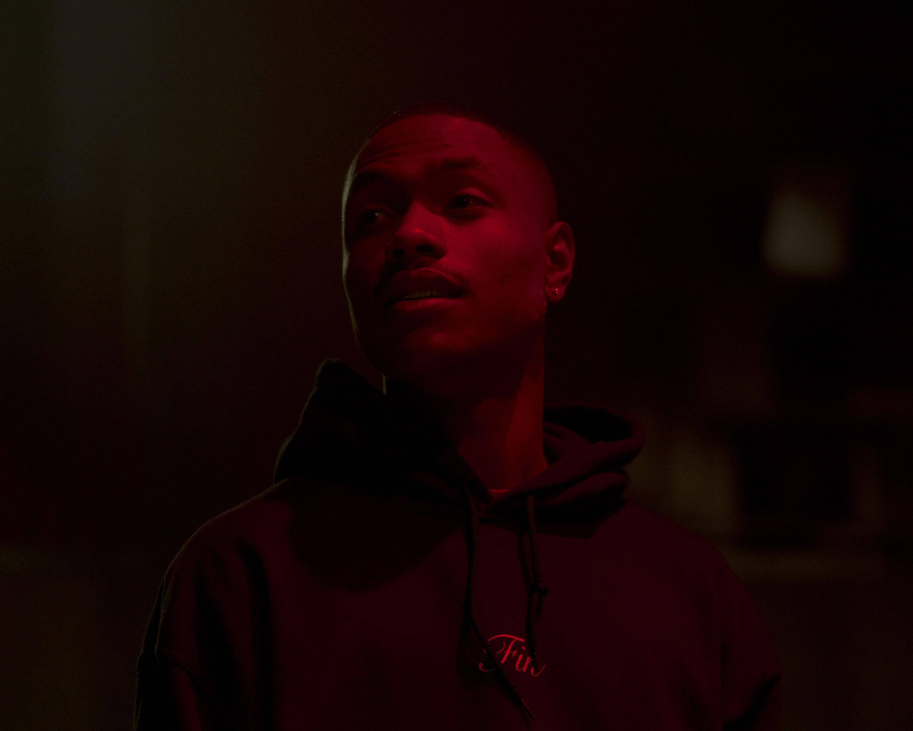 Steve Lacy, dark hoodie, intense red lighting, 2K Desktop Wallpaper