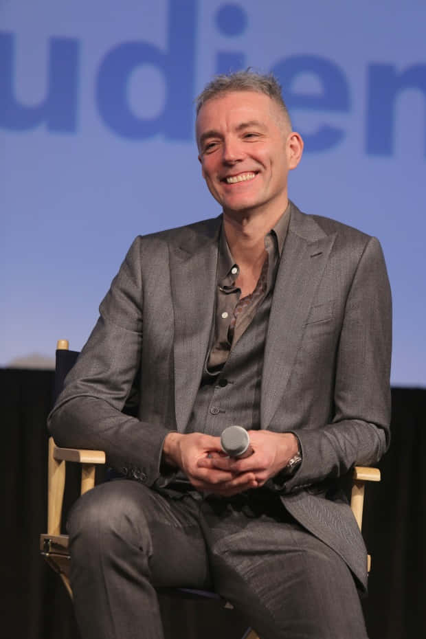 Steve Mackey, gray suit, director's chair, SD Phone Wallpaper