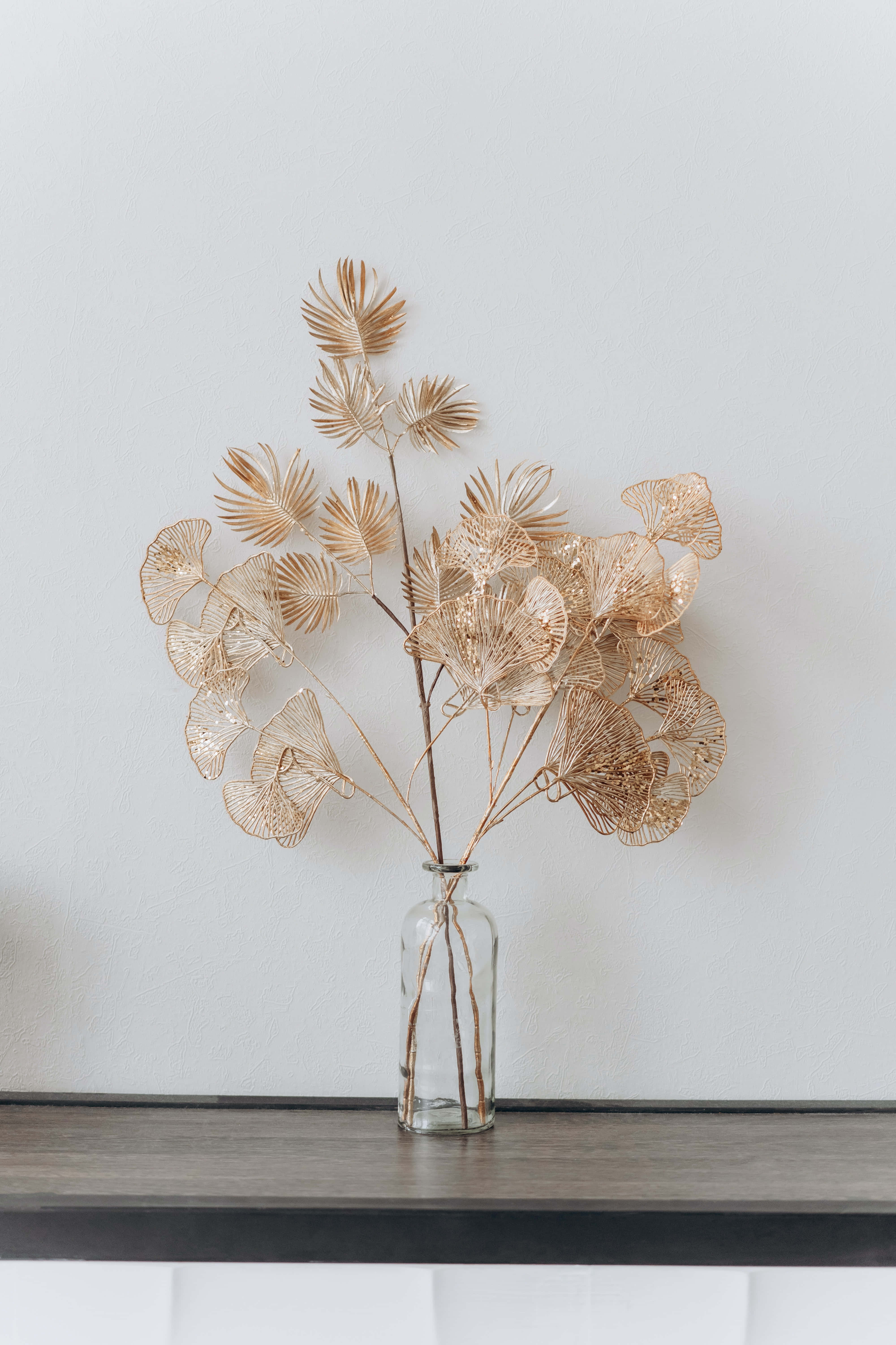 clear glass vase, golden wire ginkgo leaves, plain white wall, 5K Phone Wallpaper