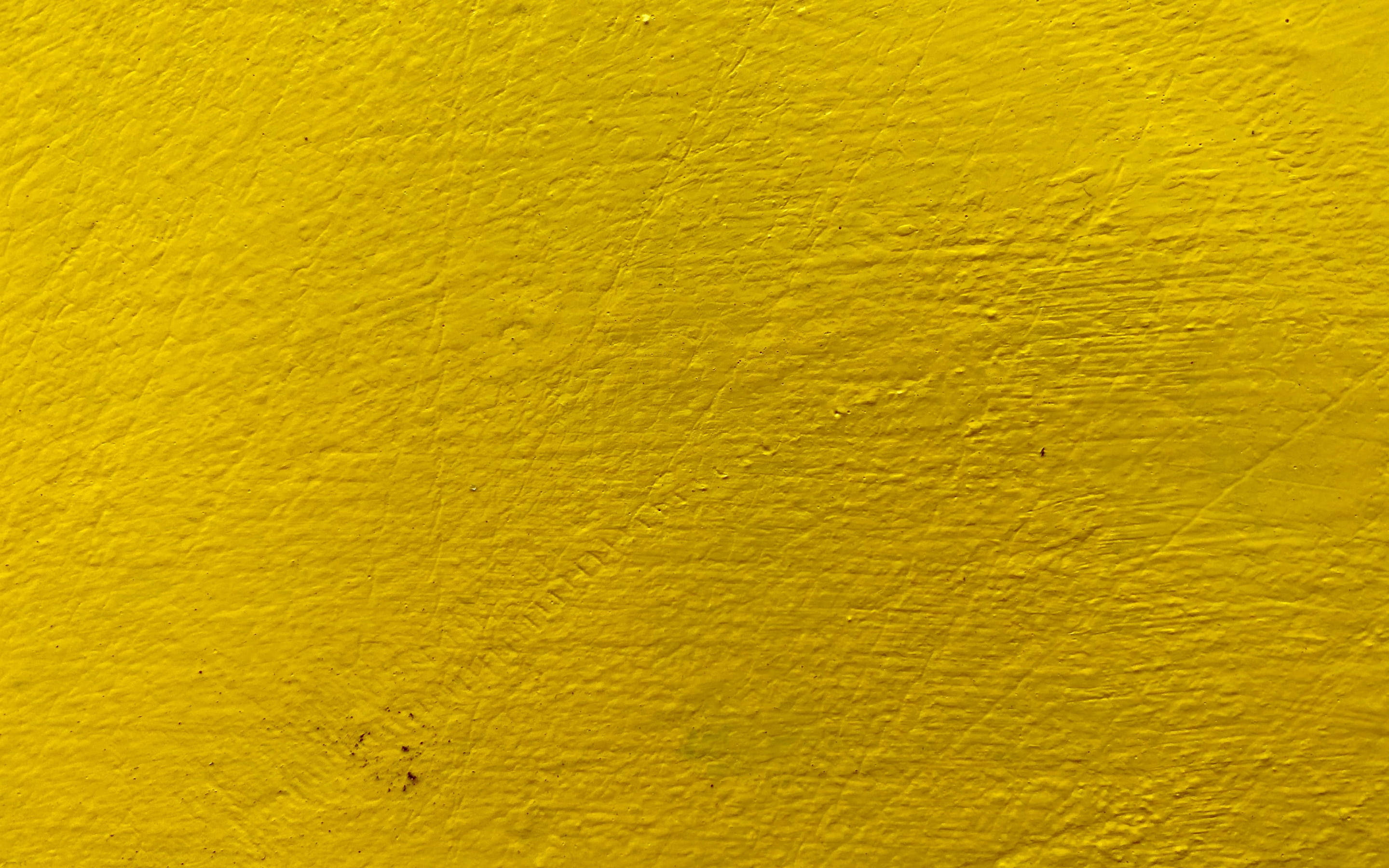 textured bright yellow stone wall, vibrant yellow painted wall, textured brush strokes, 2K Desktop Wallpaper