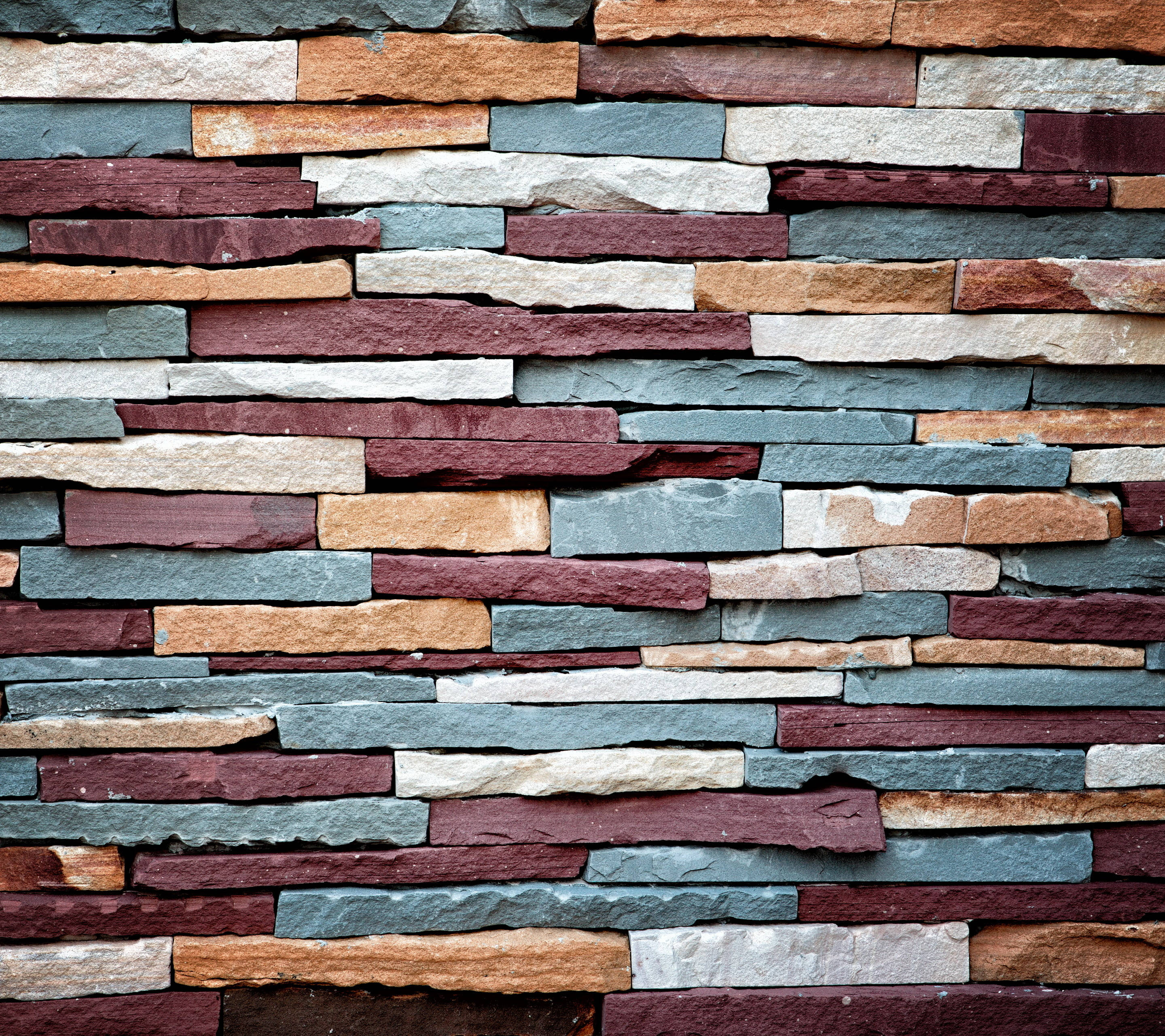 colorful stone wall cladding, stacked stone wall, rich reds oranges grays and whites, 2K Desktop Wallpaper