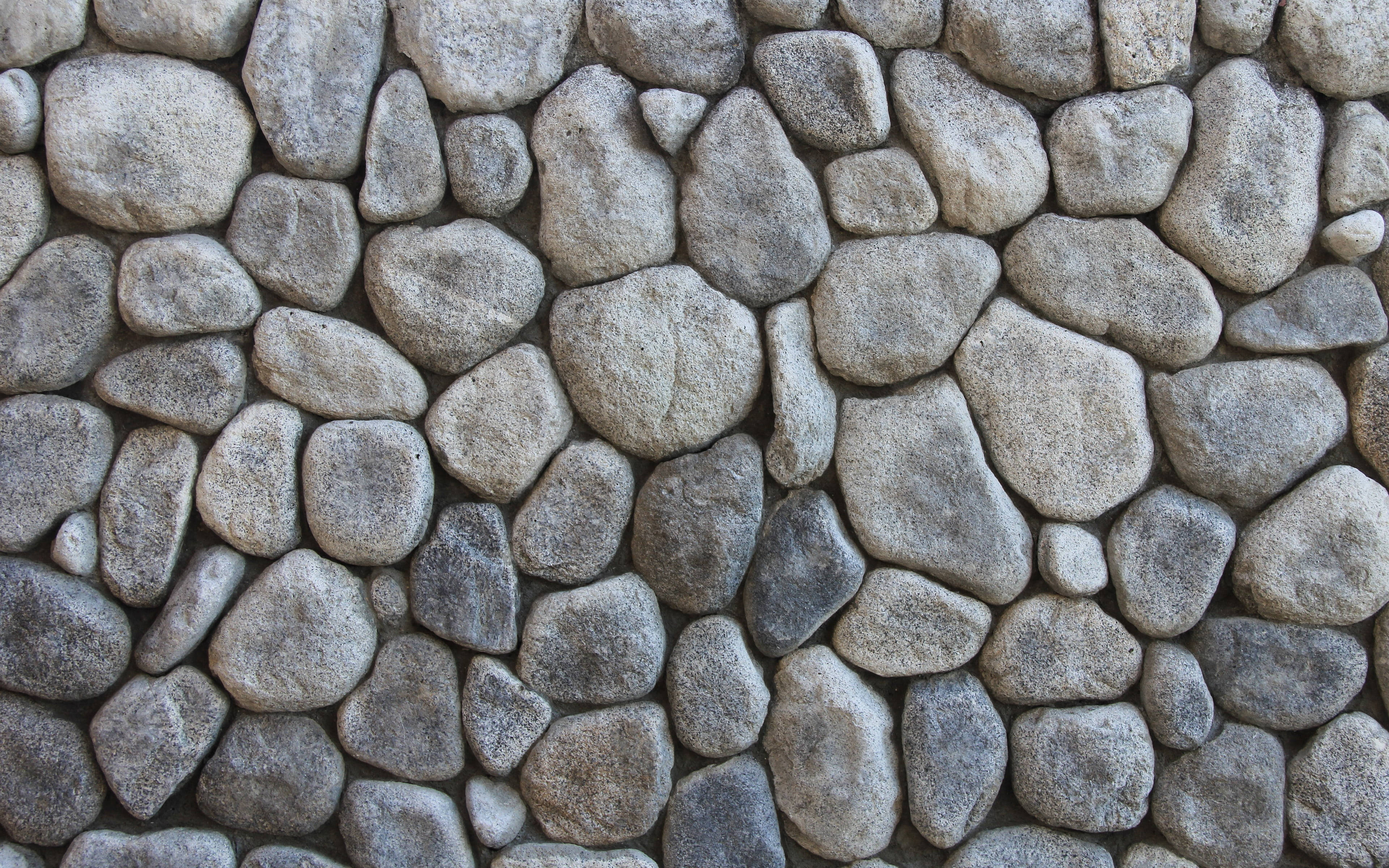 simple stone wall mosaic desktop, textured stone wall, irregularly shaped gray and beige rocks, 4K Desktop Wallpaper