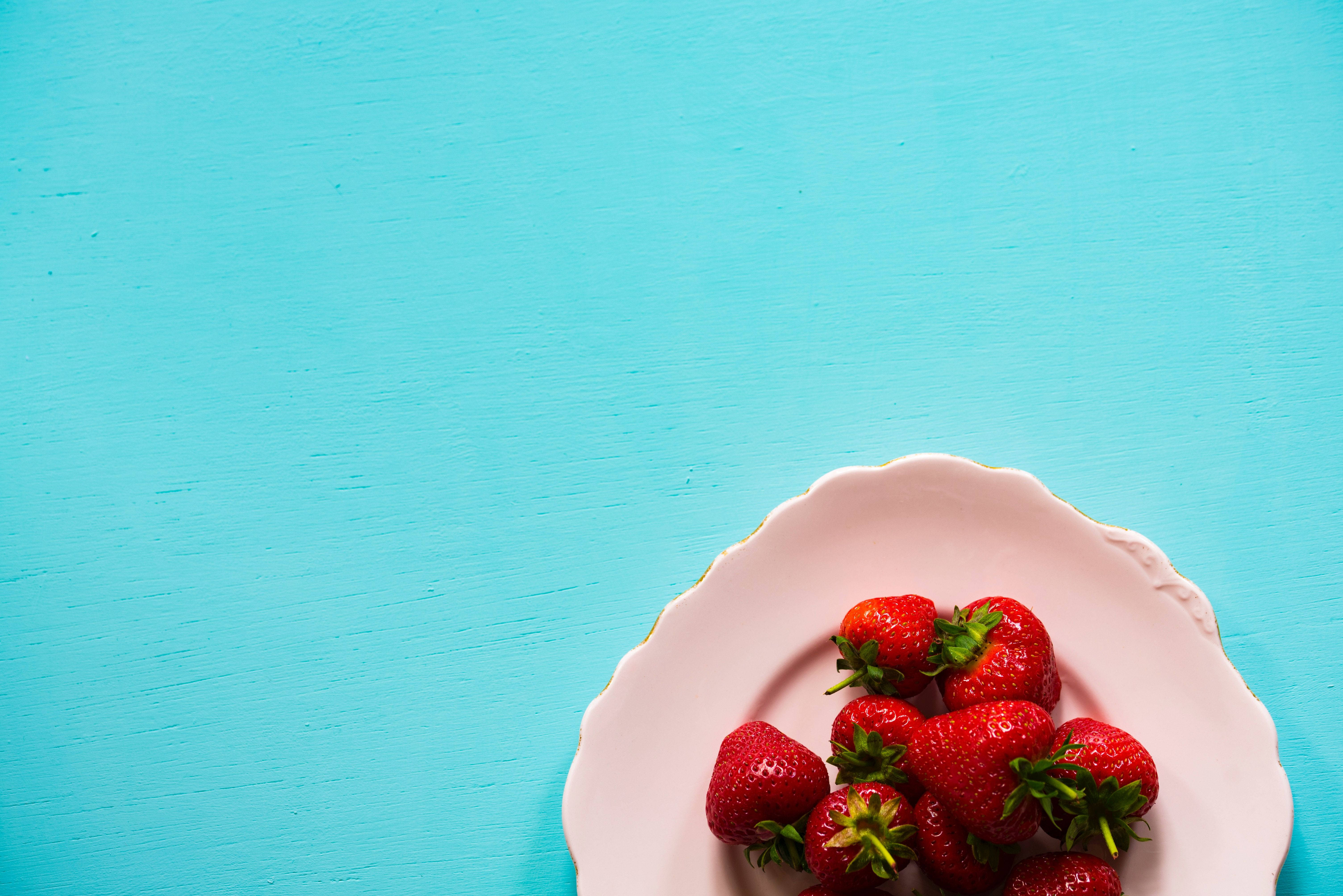 sapphire blue desk, pink scalloped plate, fresh red strawberries, 5K Desktop Wallpaper