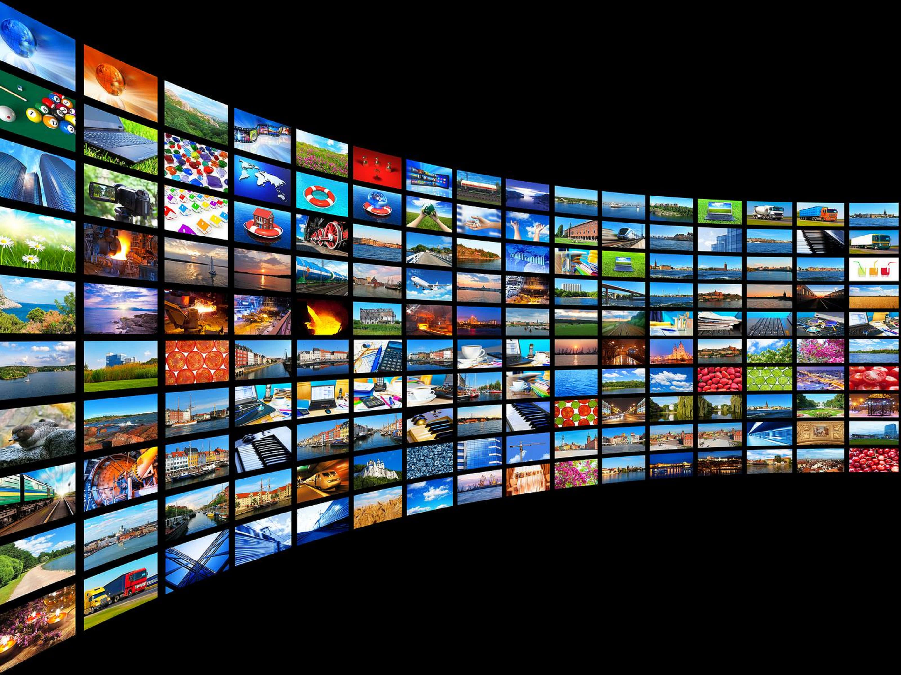 4K Streaming Experience, curved wall of glowing screens, vibrant collage of diverse global scenes, 2K Desktop Wallpaper