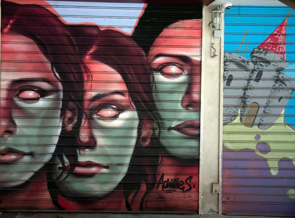 Vivid graffiti mural, metal shutters, three haunting faces, SD Desktop Wallpaper