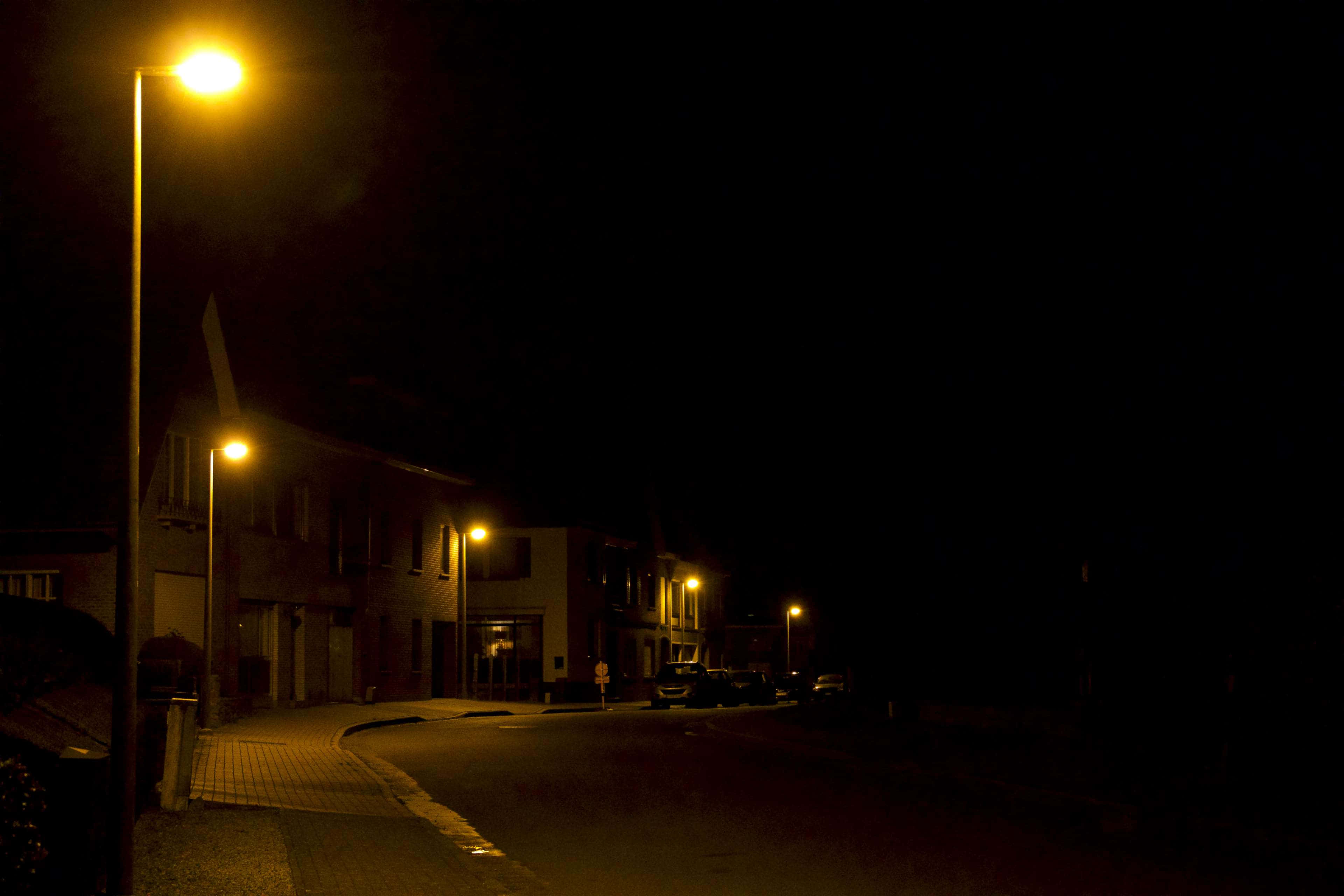 Night Street, warm yellow streetlights, wet pavement, 4K Desktop Wallpaper