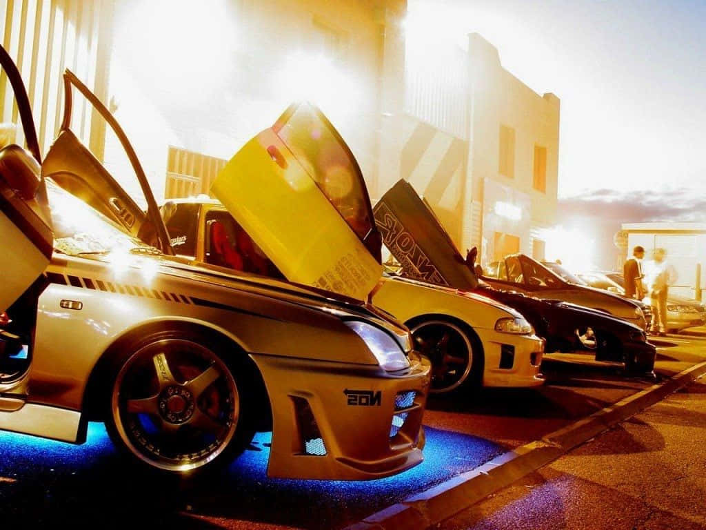 drift cars, glowing blue underglow, sunlit urban lot, SD Desktop Wallpaper