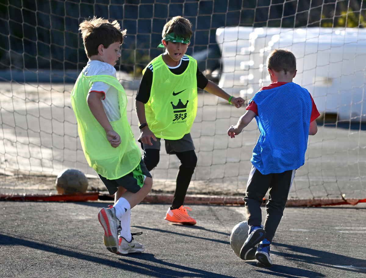 Street Soccer, bright training vests, sunny asphalt court, SD Desktop Wallpaper