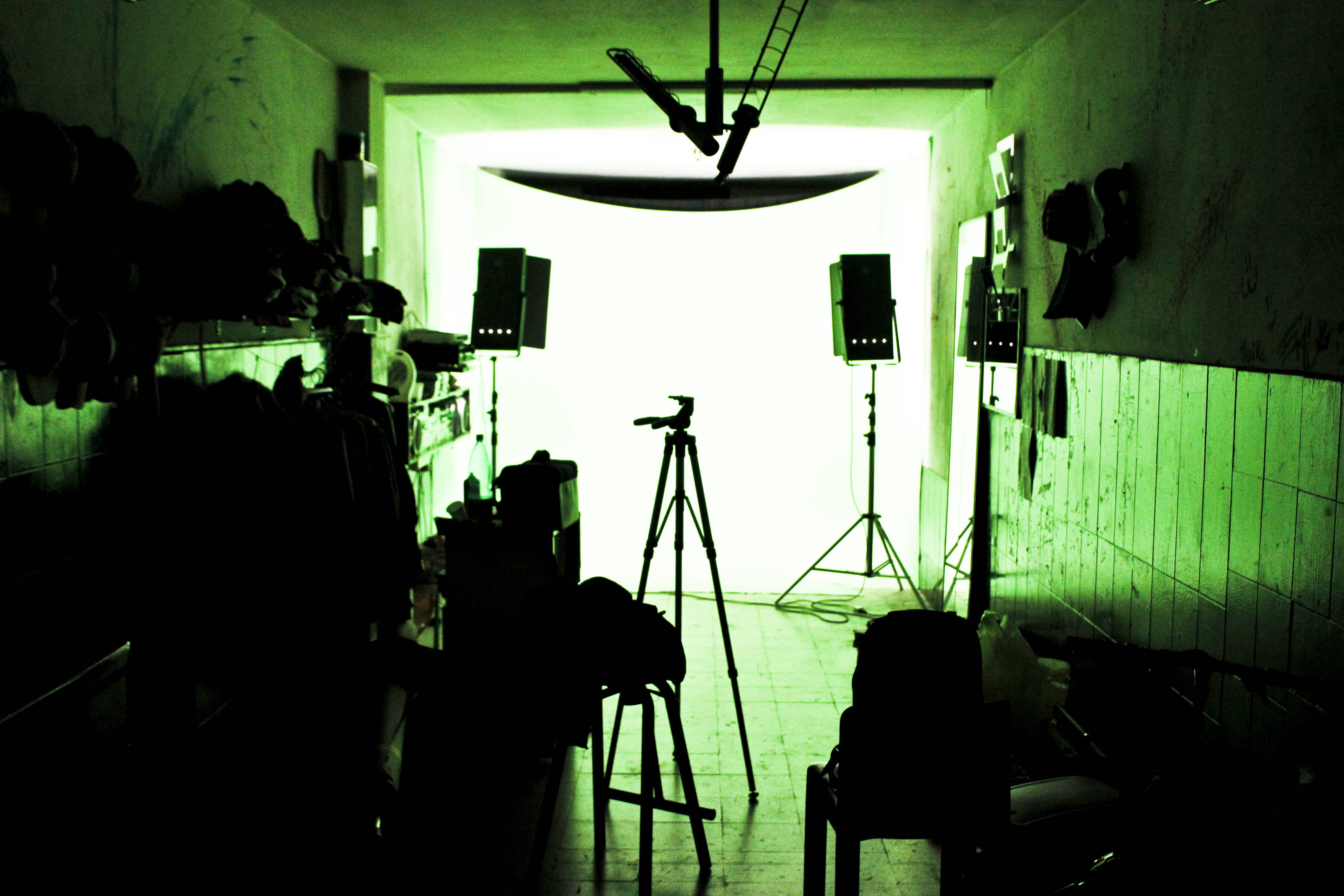 green photography studio, dim green-lit room, silhouetted photography equipment, 5K Desktop Wallpaper
