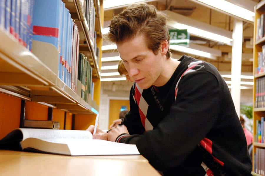 Studious Man, wooden table, towering bookshelves, SD Desktop Wallpaper