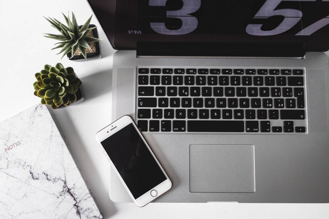 minimalist silver MacBook, sleek silver laptop, smartphone, SD Desktop Wallpaper