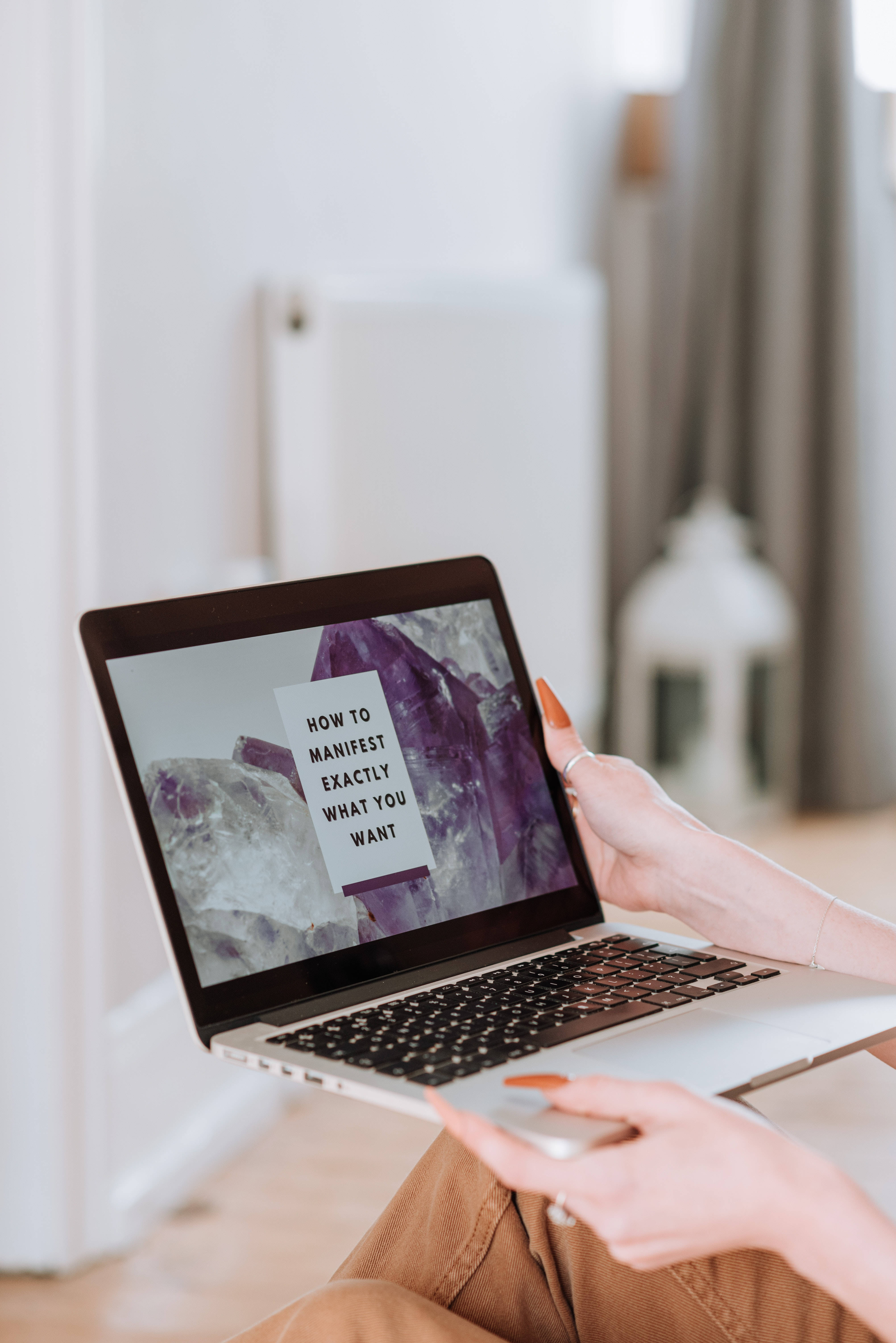 laptop, purple crystal background, text about manifestation, 5K Phone Wallpaper