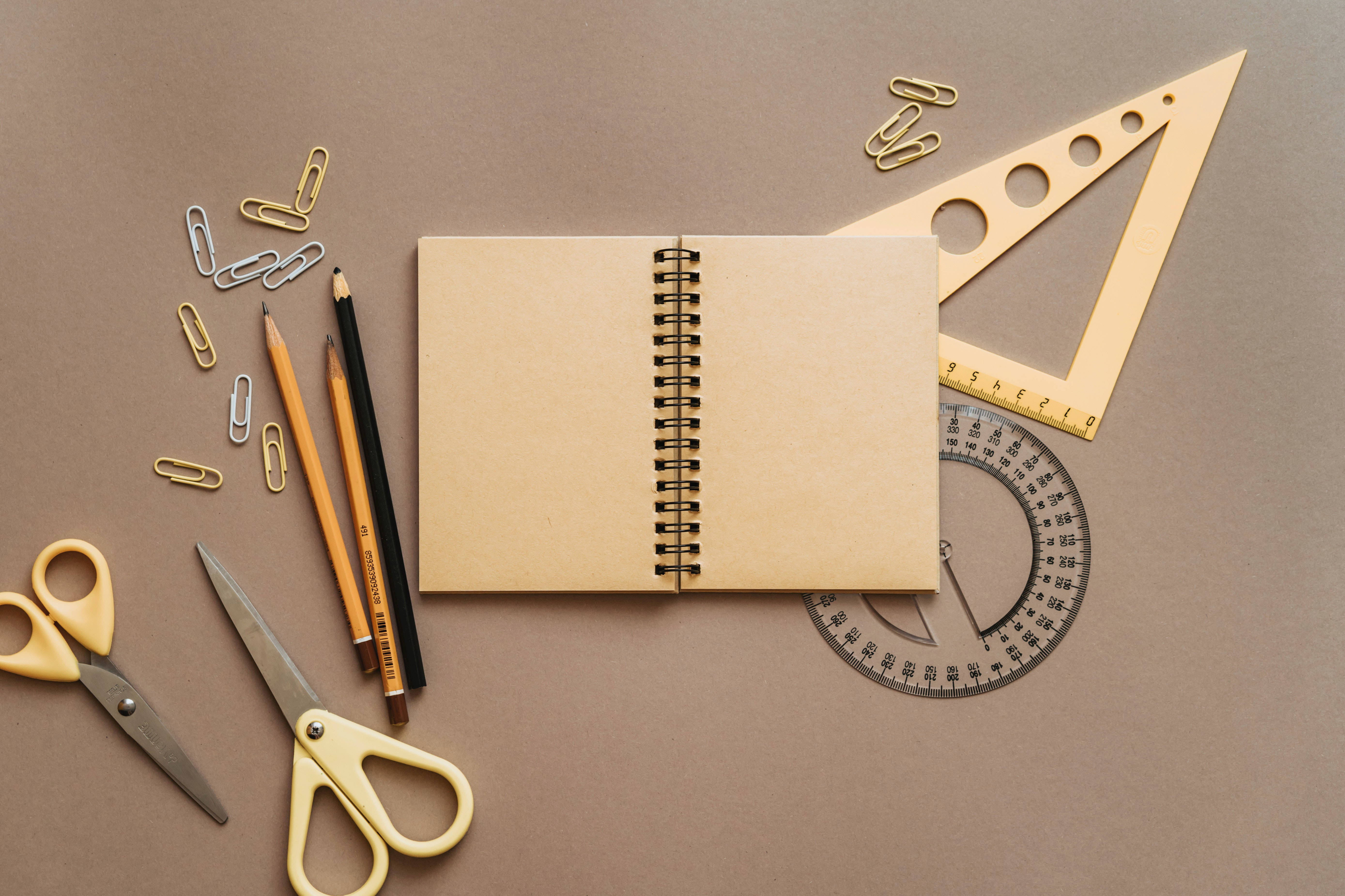 beige stationery items, spiral notebook, pencils, 5K Desktop Wallpaper