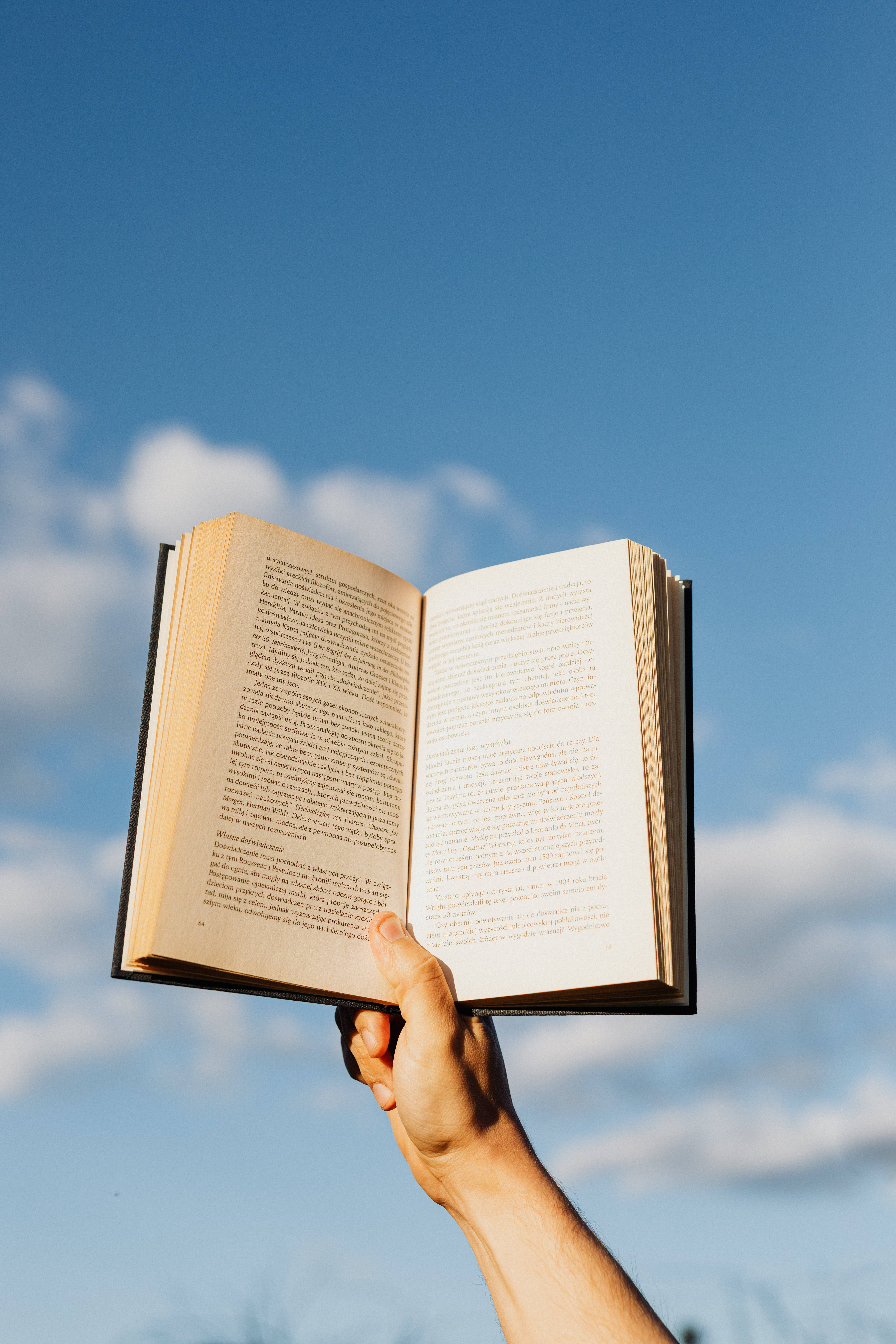 open book, bright blue sky, scattered clouds, 5K Phone Wallpaper