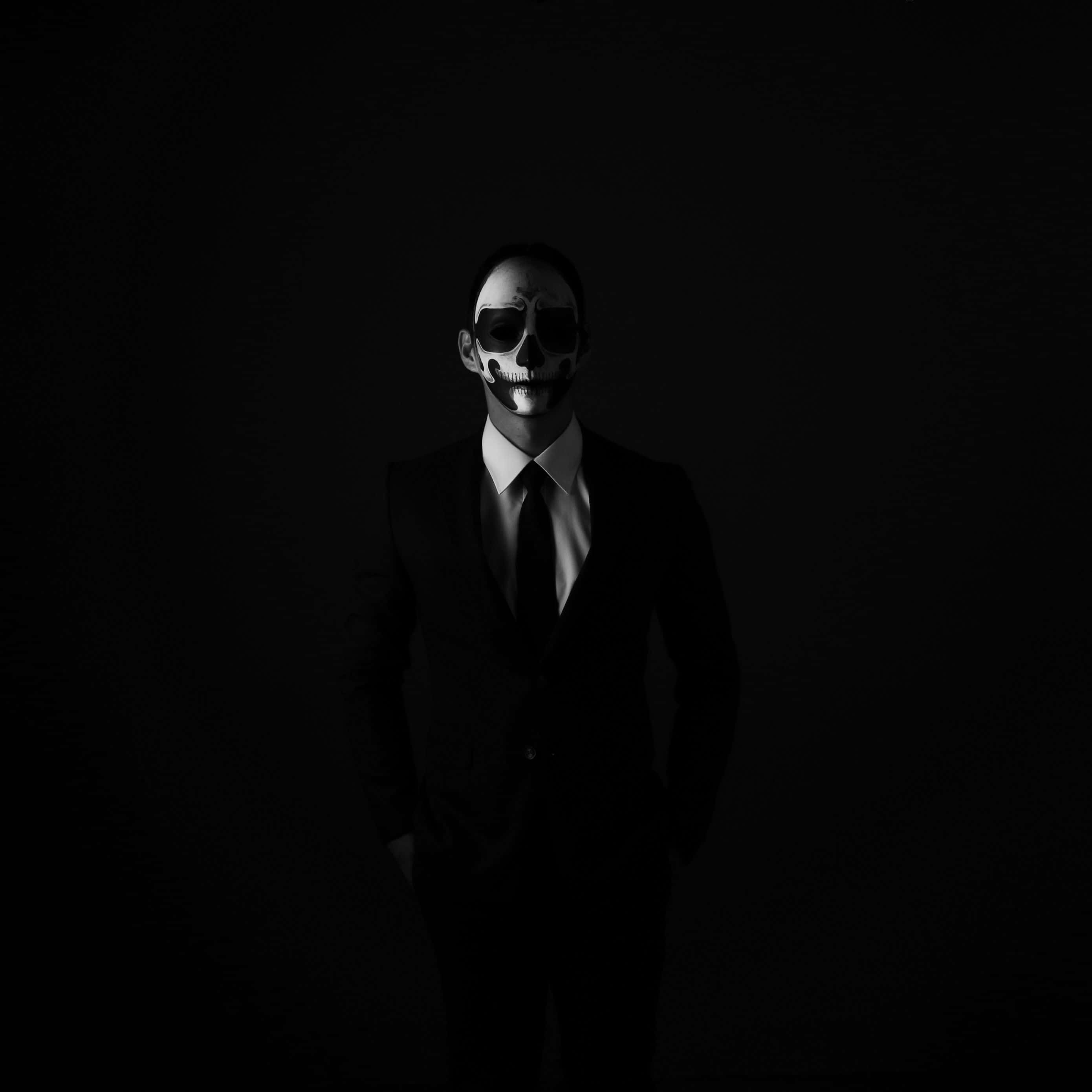 dark and gothic men suit aesthetic, painted skull face, dramatic lighting, 2K Desktop Wallpaper