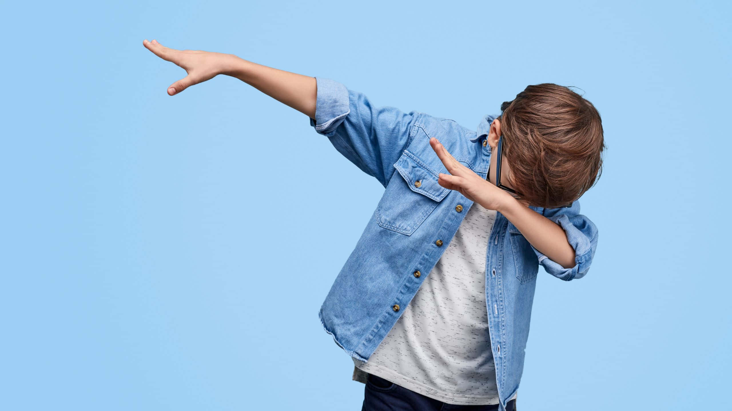 denim shirt, playful dab pose, solid blue studio background, 2K Desktop Wallpaper