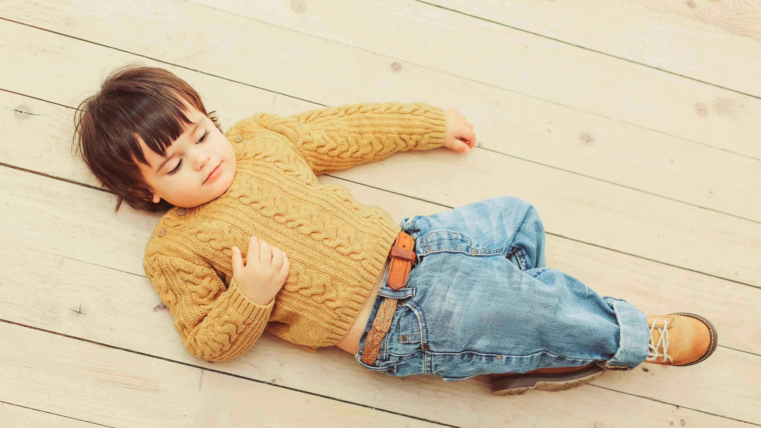 mustard cable-knit sweater, light wooden floorboards, sleepy toddler, 2K Desktop Wallpaper