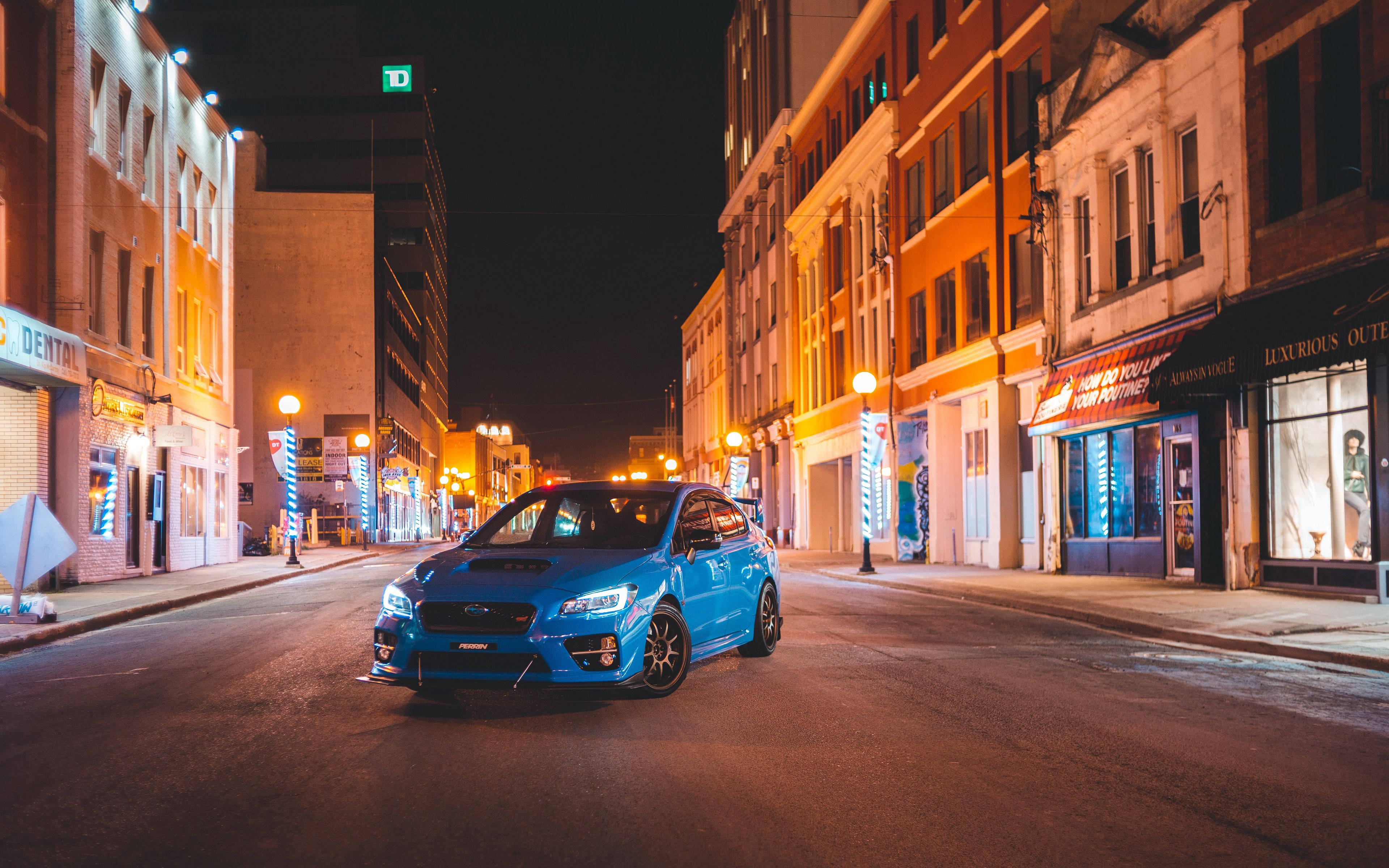Subaru WRX STI, vibrant blue, warm streetlights, 4K Desktop Wallpaper
