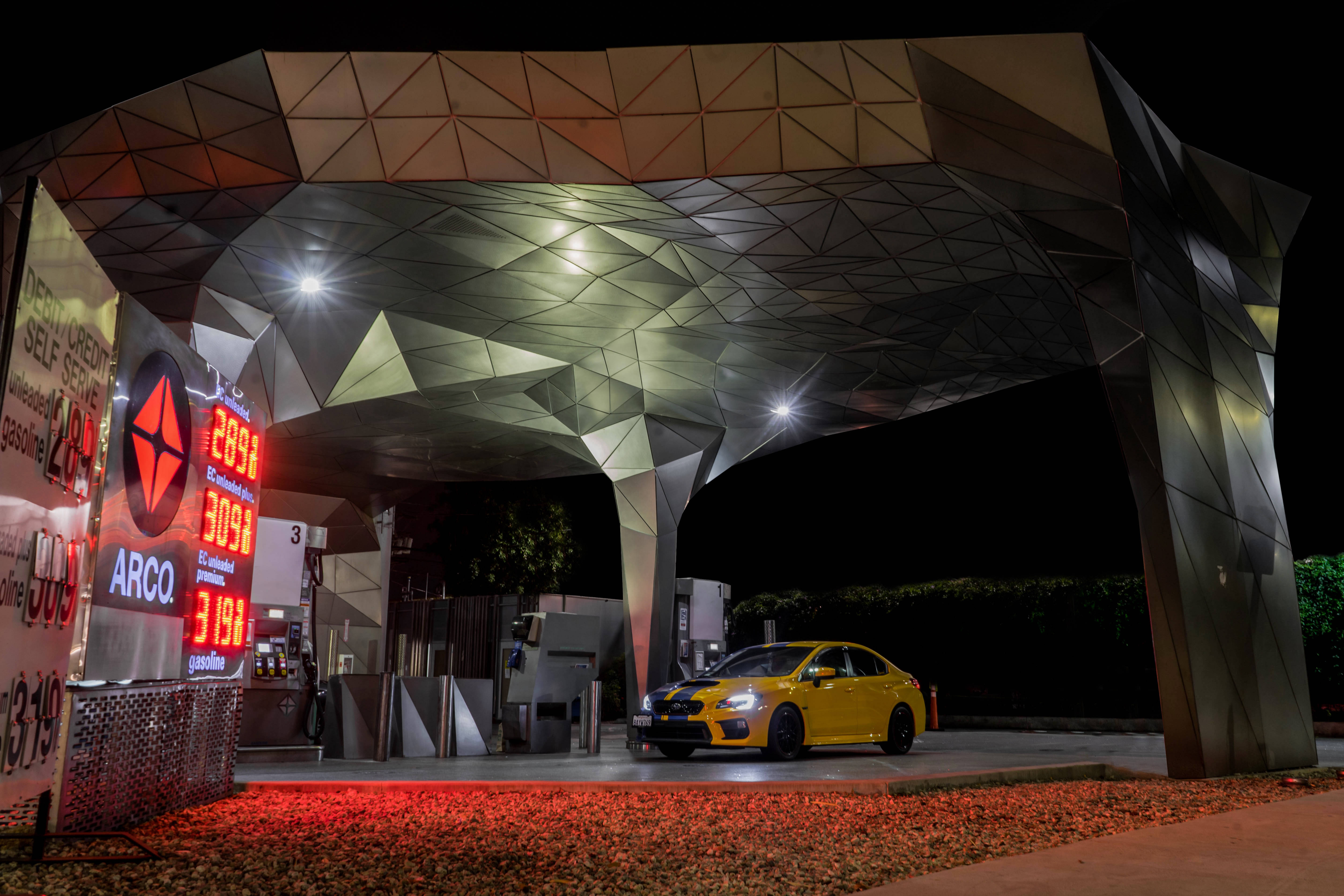 Subaru WRX STI, vibrant yellow, geometrically faceted gas station canopy, 5K Desktop Wallpaper