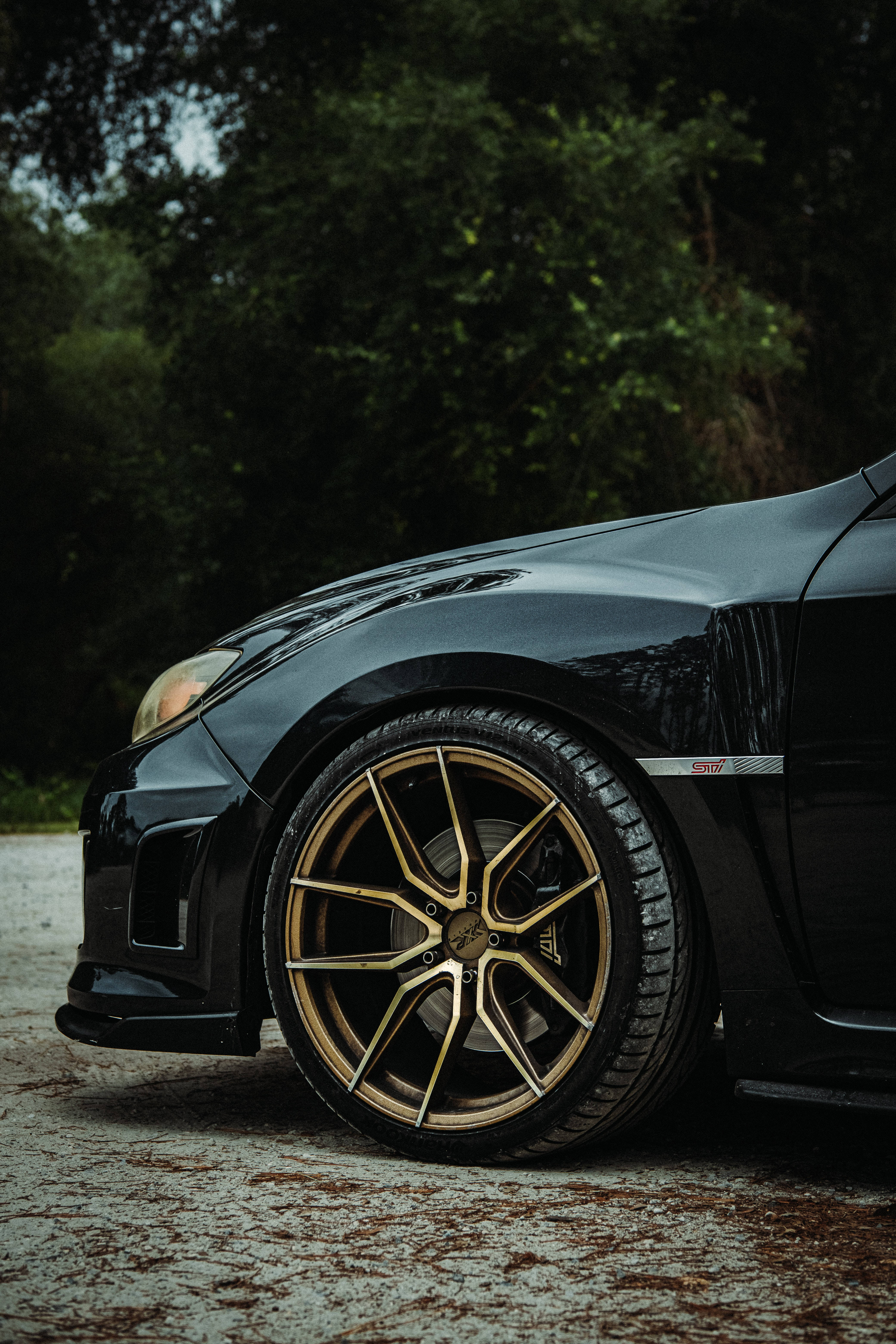 Subaru WRX STI, gold rims, sleek black sports car, 5K Phone Wallpaper