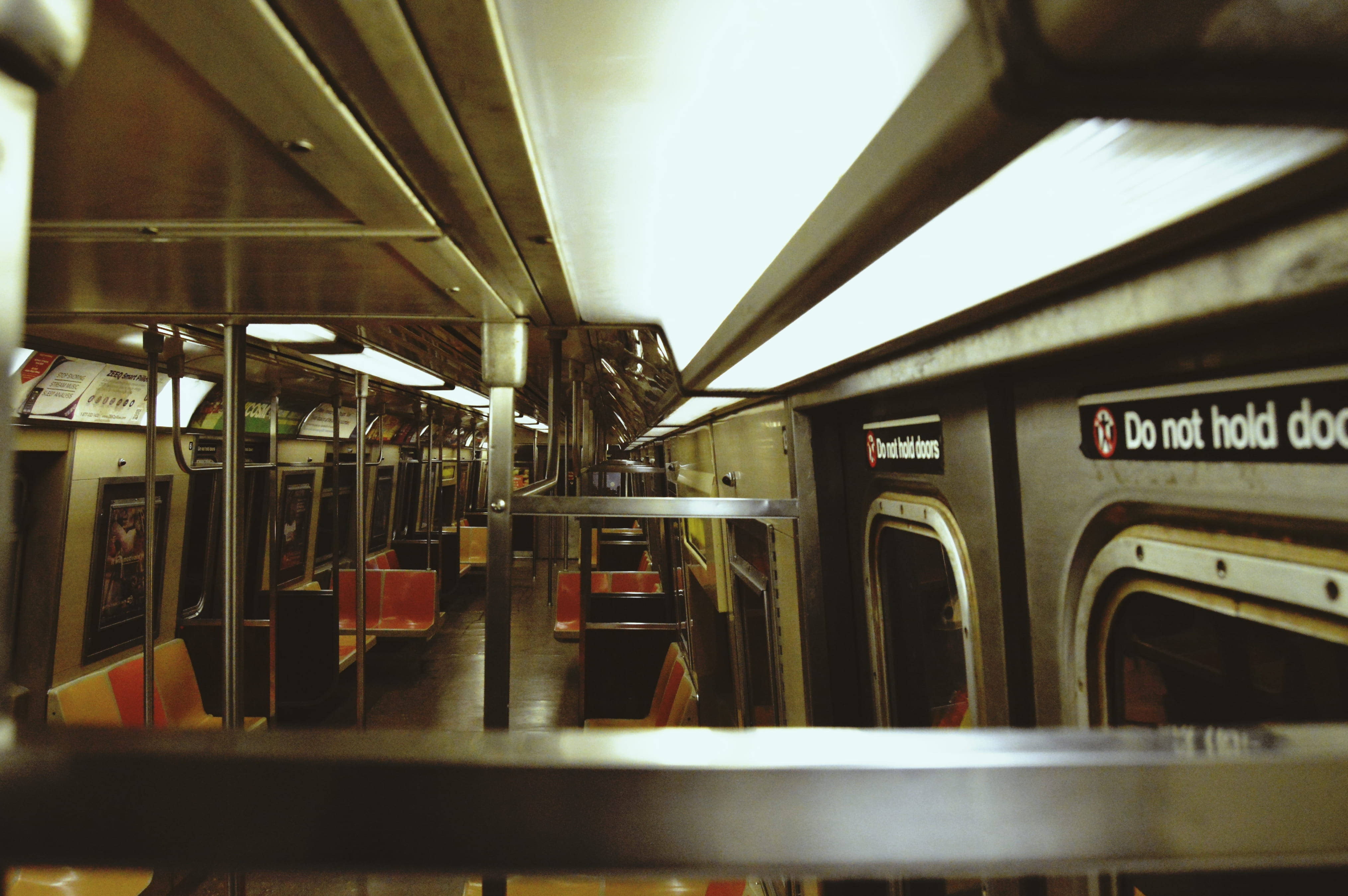 subway car, orange seats, overhead lights, 4K Desktop Wallpaper