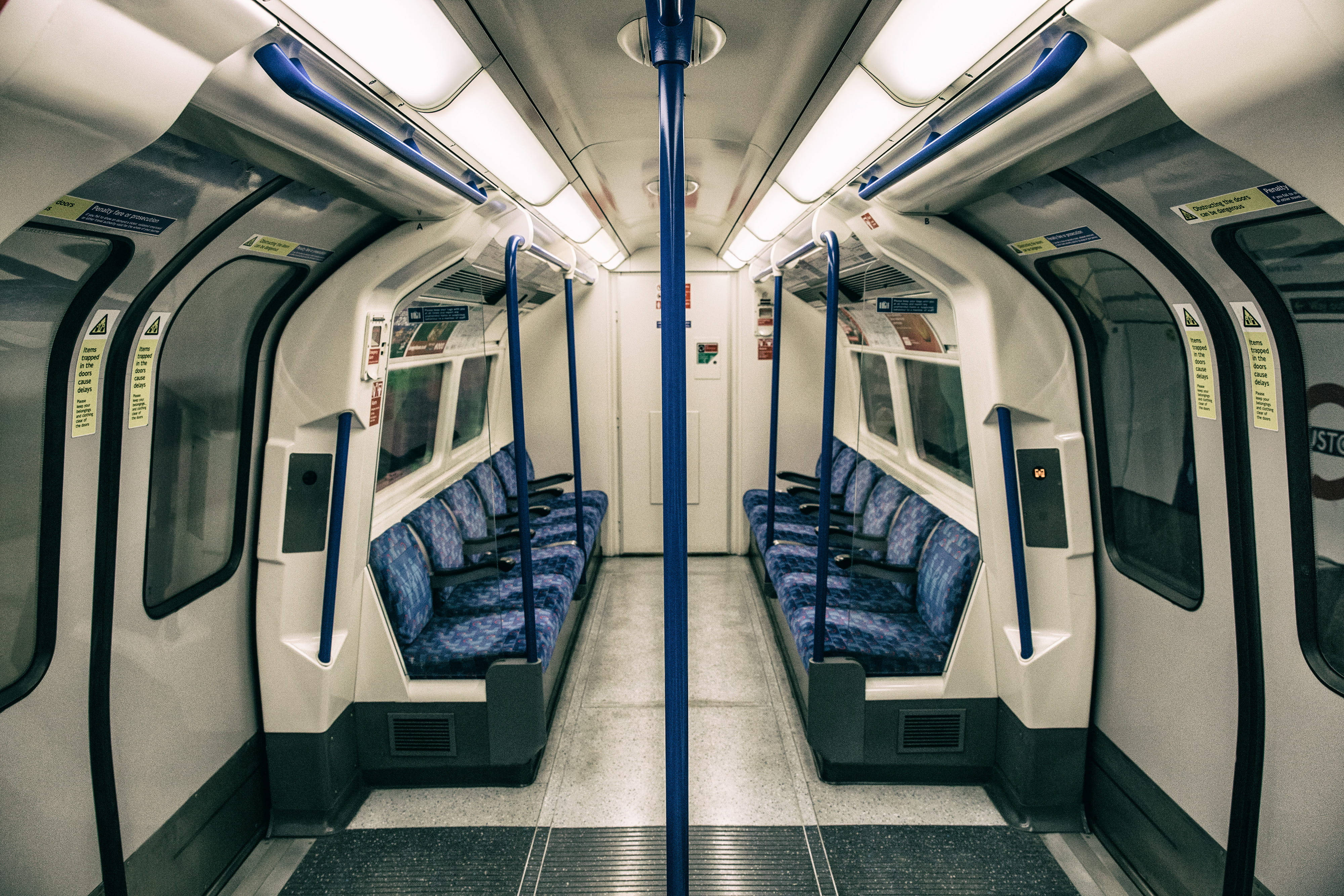 modern subway train, blue patterned seats, overhead handrails, 4K Desktop Wallpaper