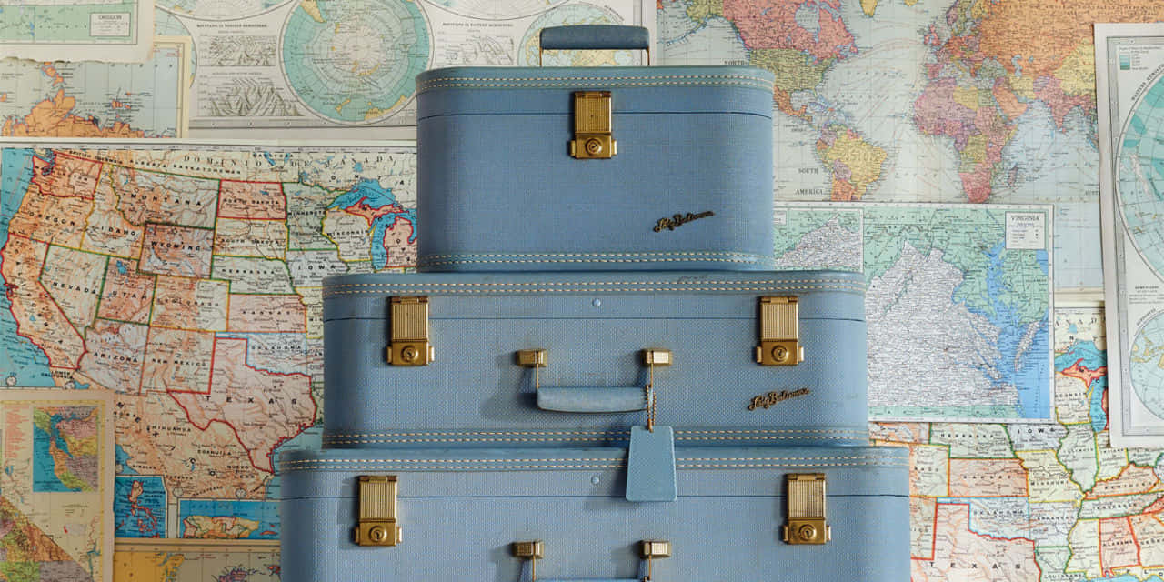 vintage blue suitcases, brass hardware, colorful collage of world maps, HD Desktop Wallpaper
