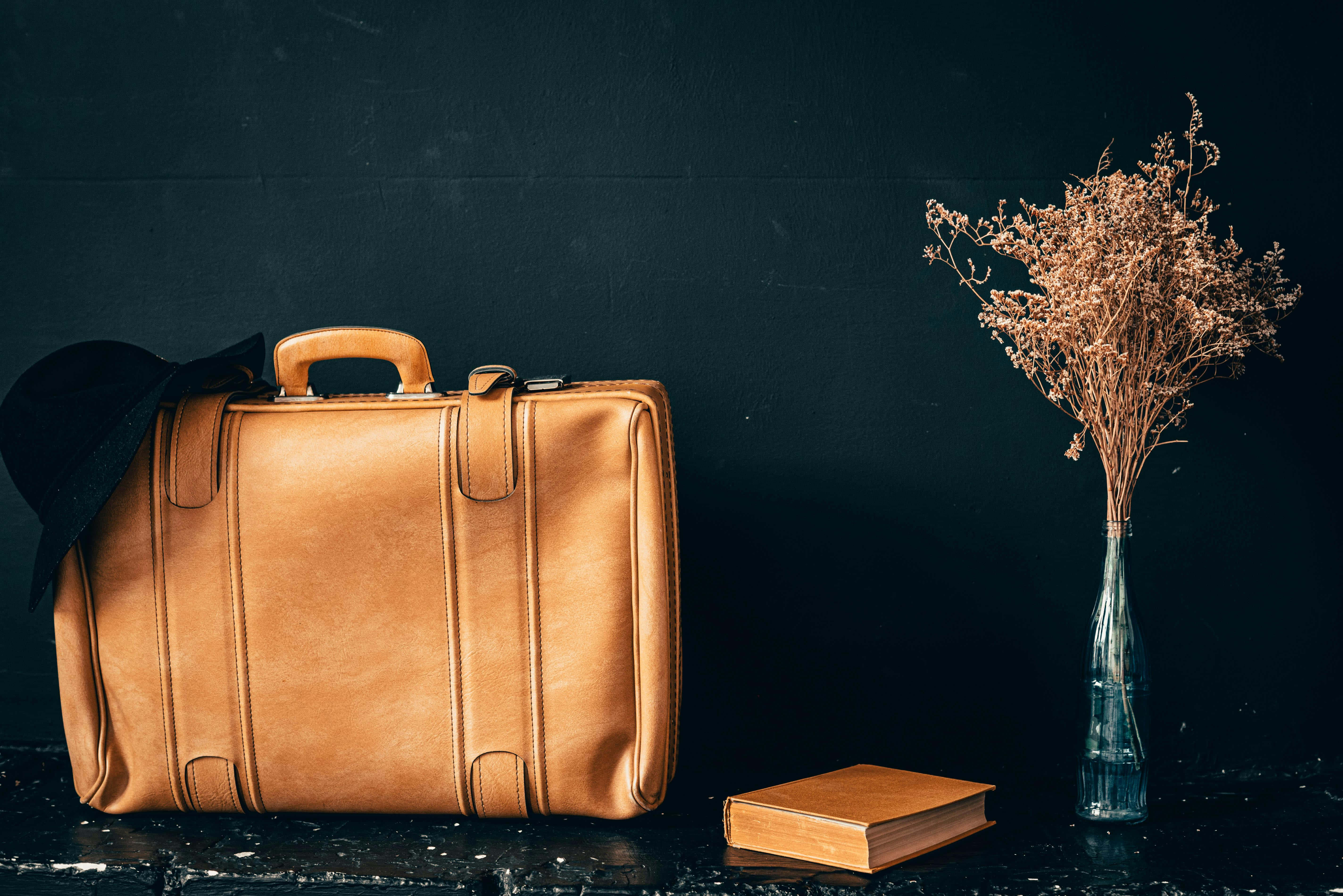 vintage tan leather suitcase, black hat, glass vase of dried flowers, 5K Desktop Wallpaper