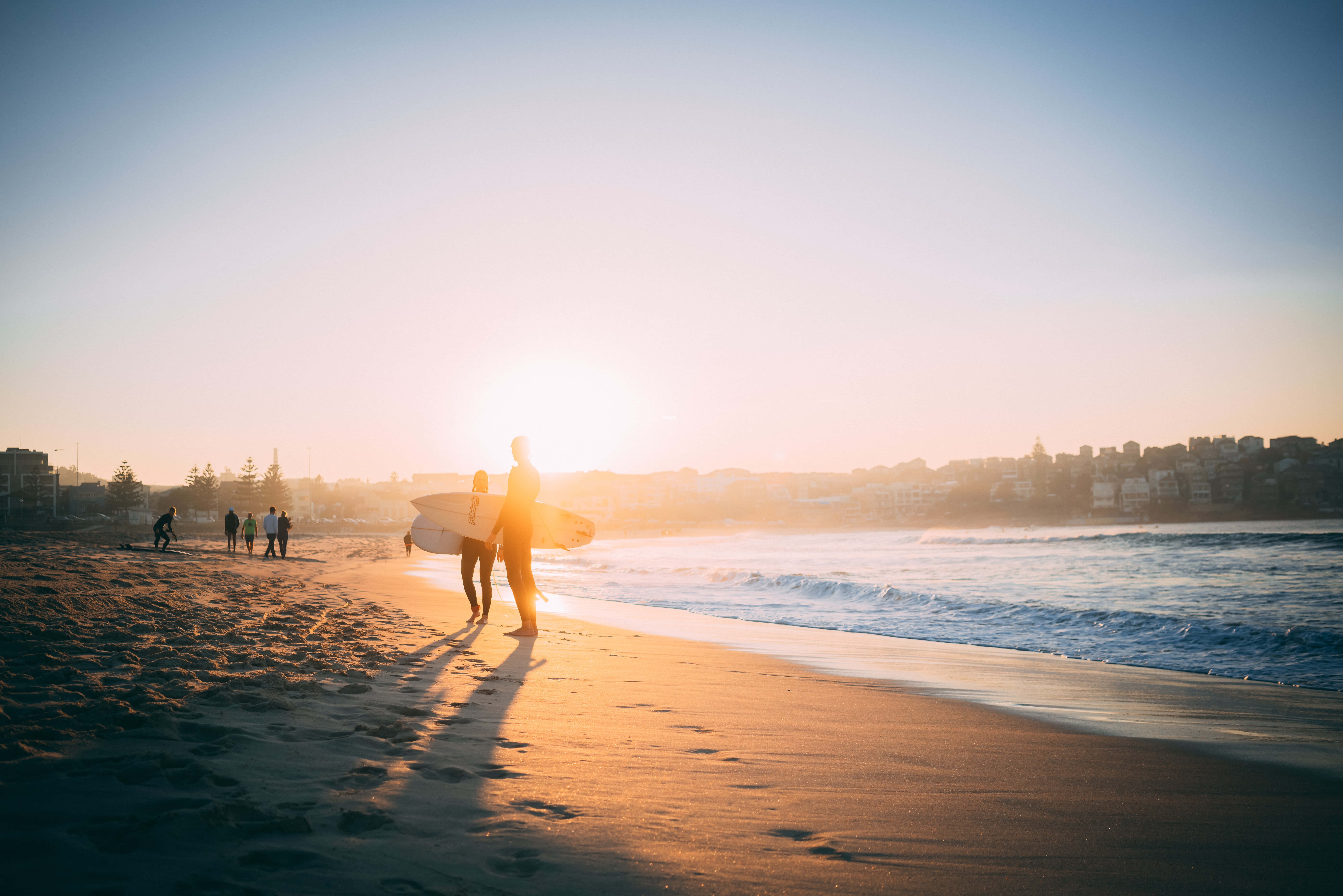 golden hour, sunlit beach, waves rolling in, 8K Desktop Wallpaper