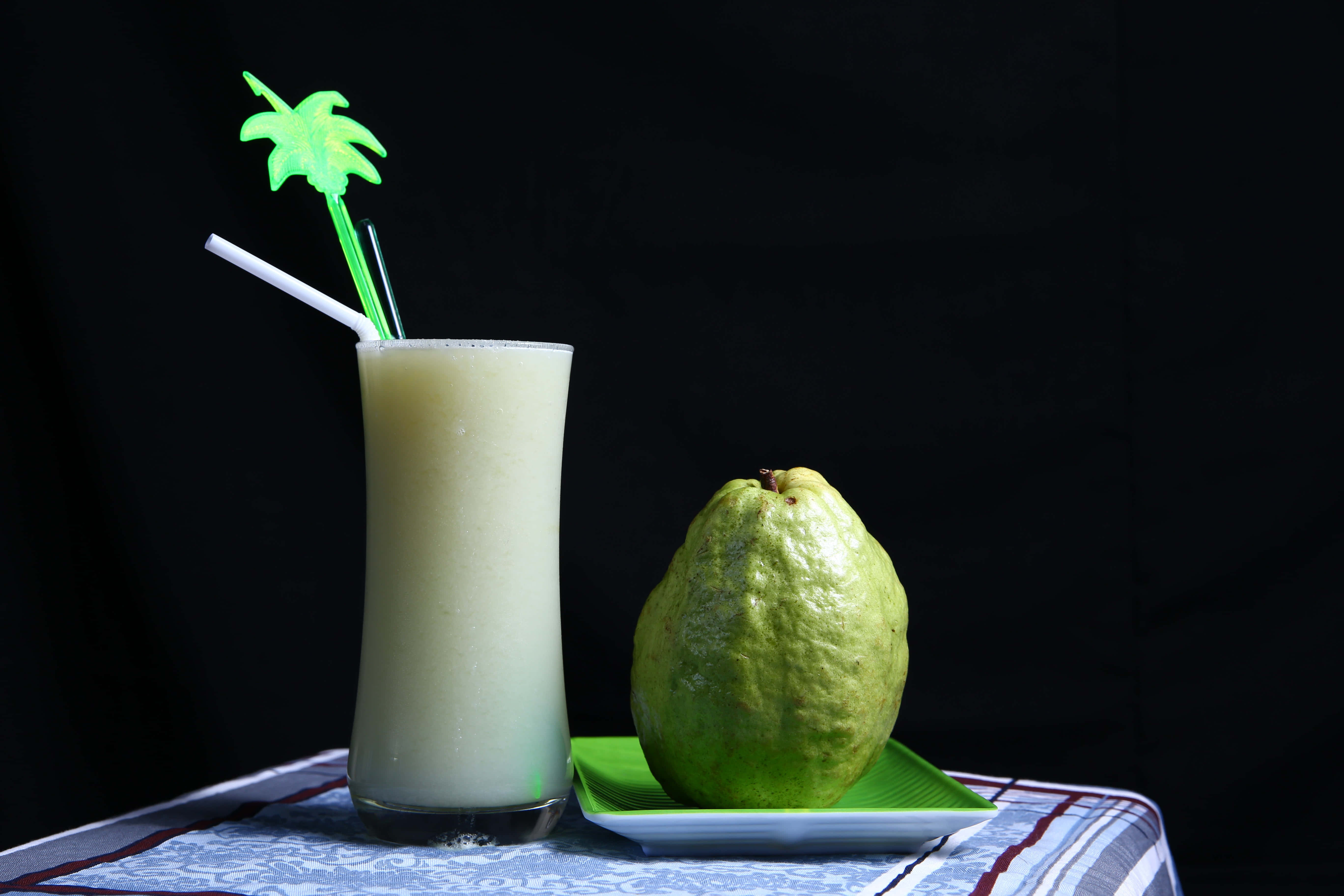 creamy pale green guava smoothie, tall glass, glowing green palm straw, 5K Desktop Wallpaper
