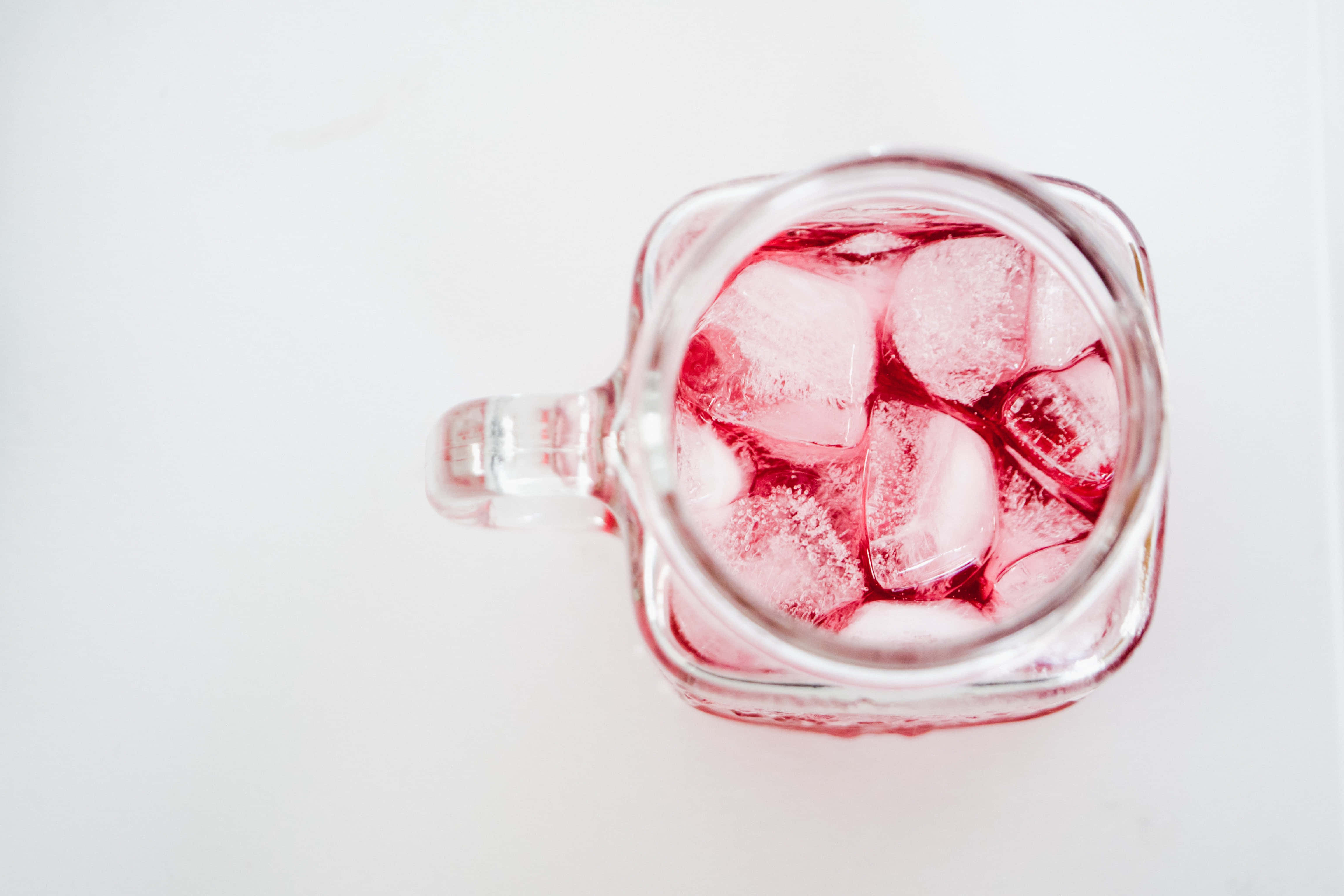 pink liquid, melting ice cubes, clear glass mug, 4K Desktop Wallpaper