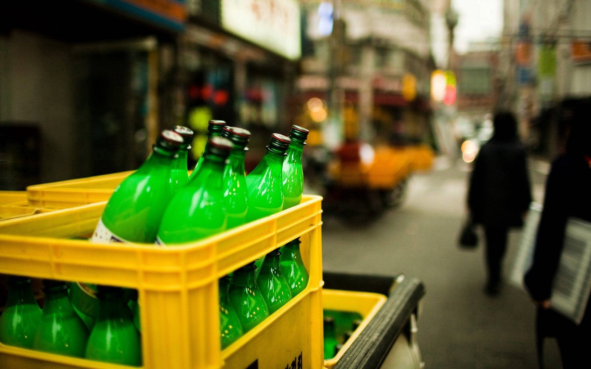 vibrant green bottles, yellow crate, urban street scene, Full HD Desktop Wallpaper