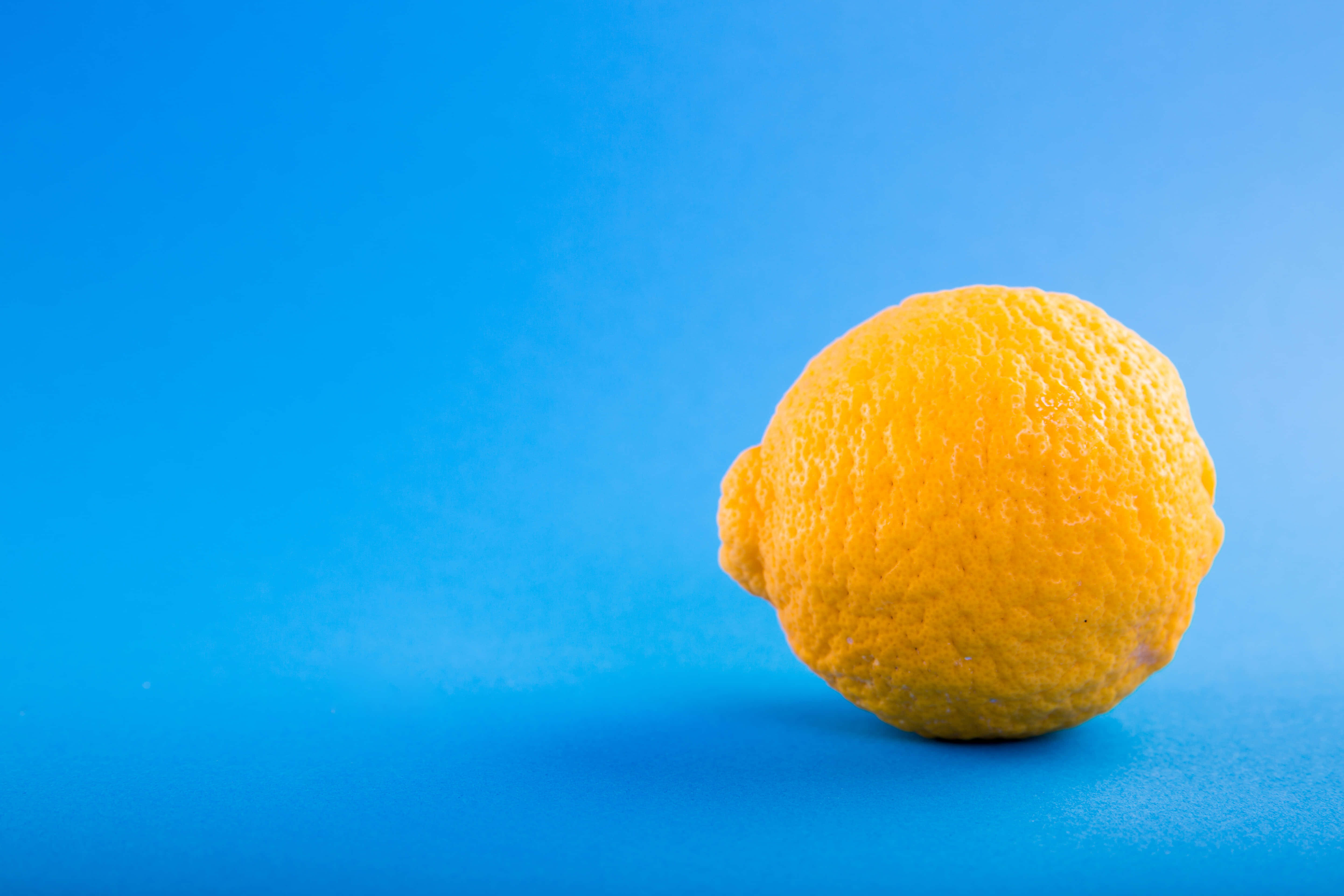 summer fruits, yellow lemon, solid blue surface, 5K Desktop Wallpaper