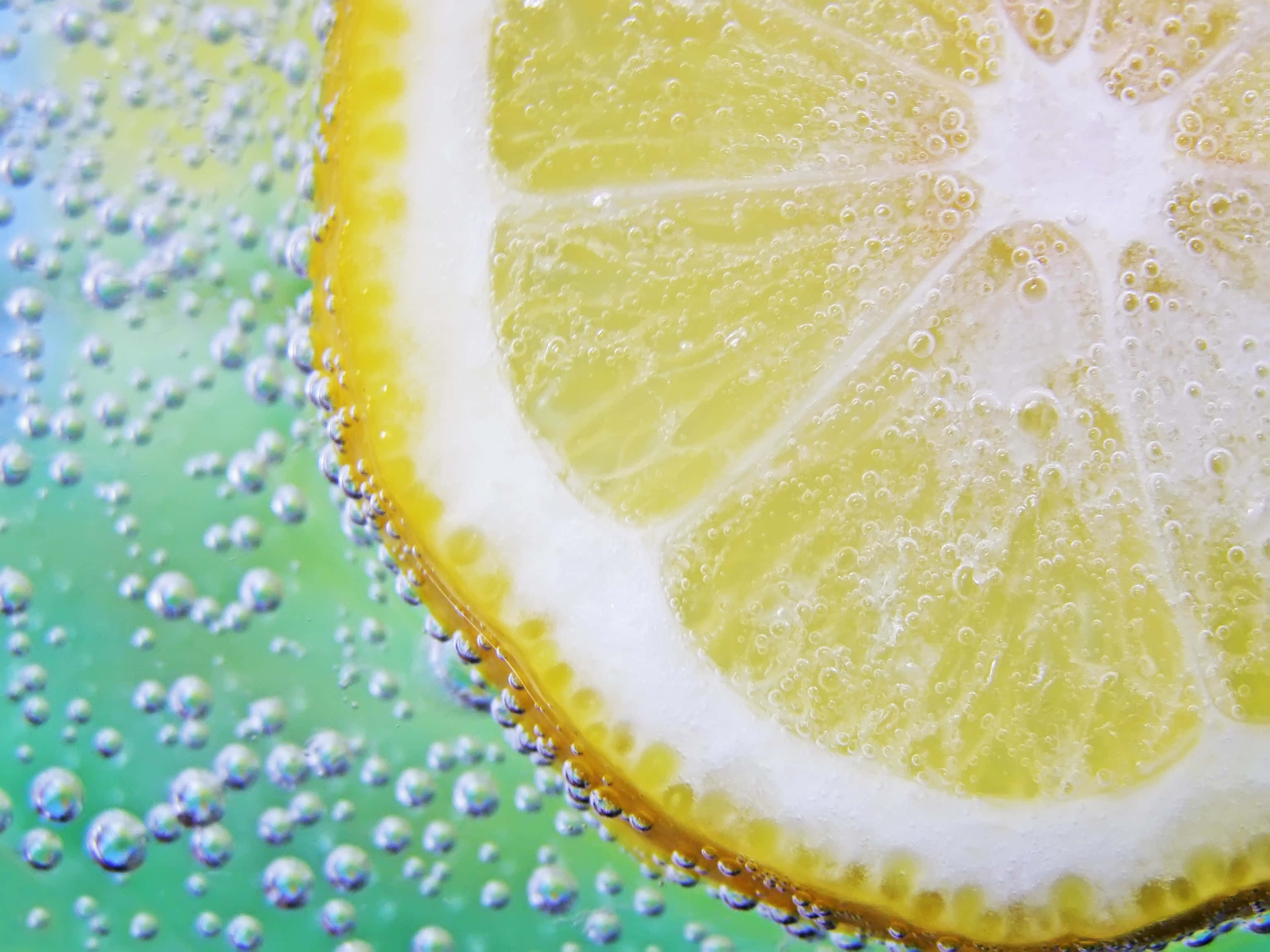 lemon slice, fizzy green liquid, sparkling bubbles, 2K Desktop Wallpaper