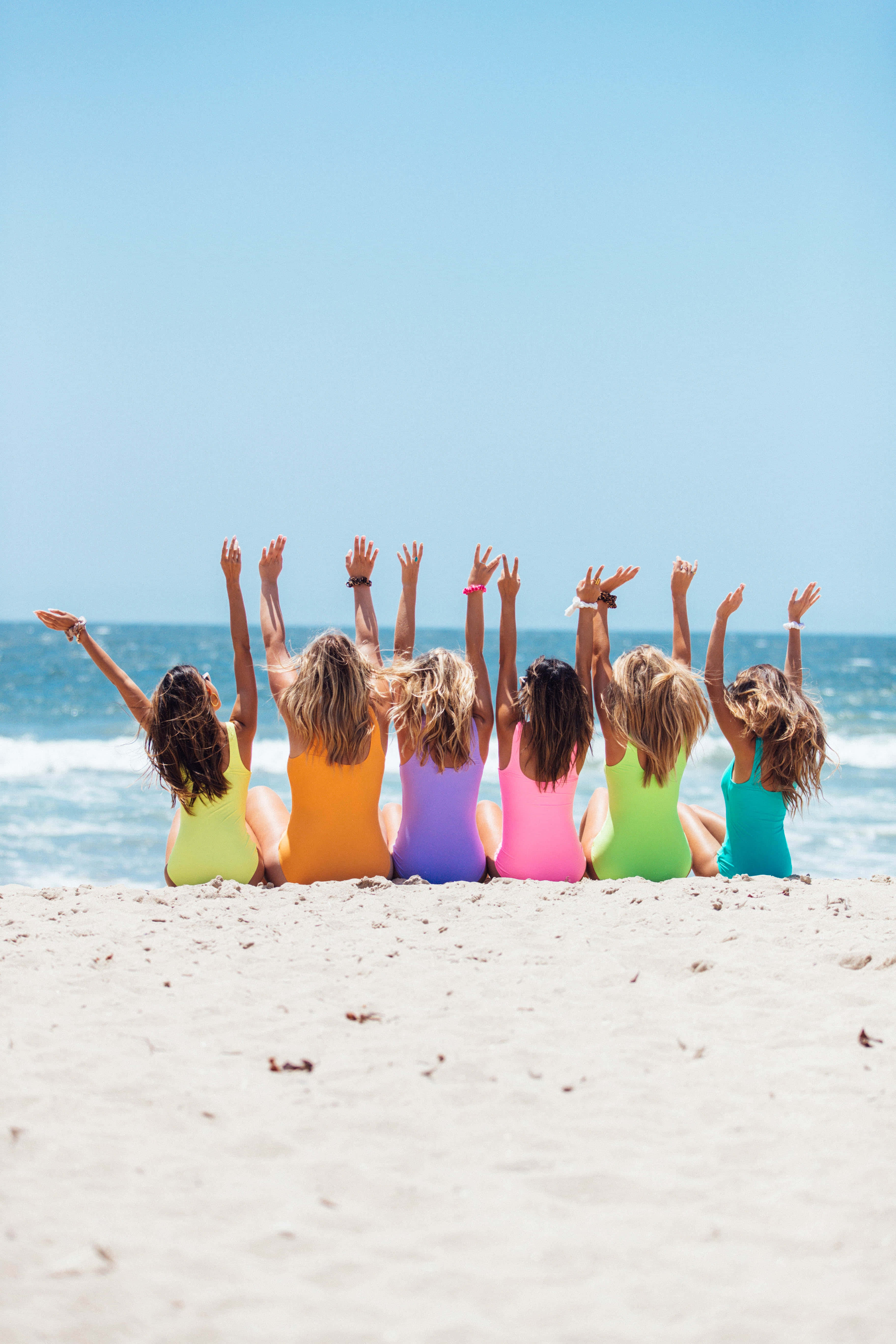 rainbow-colored swimsuits, sandy beach, clear blue sky, 5K Phone Wallpaper