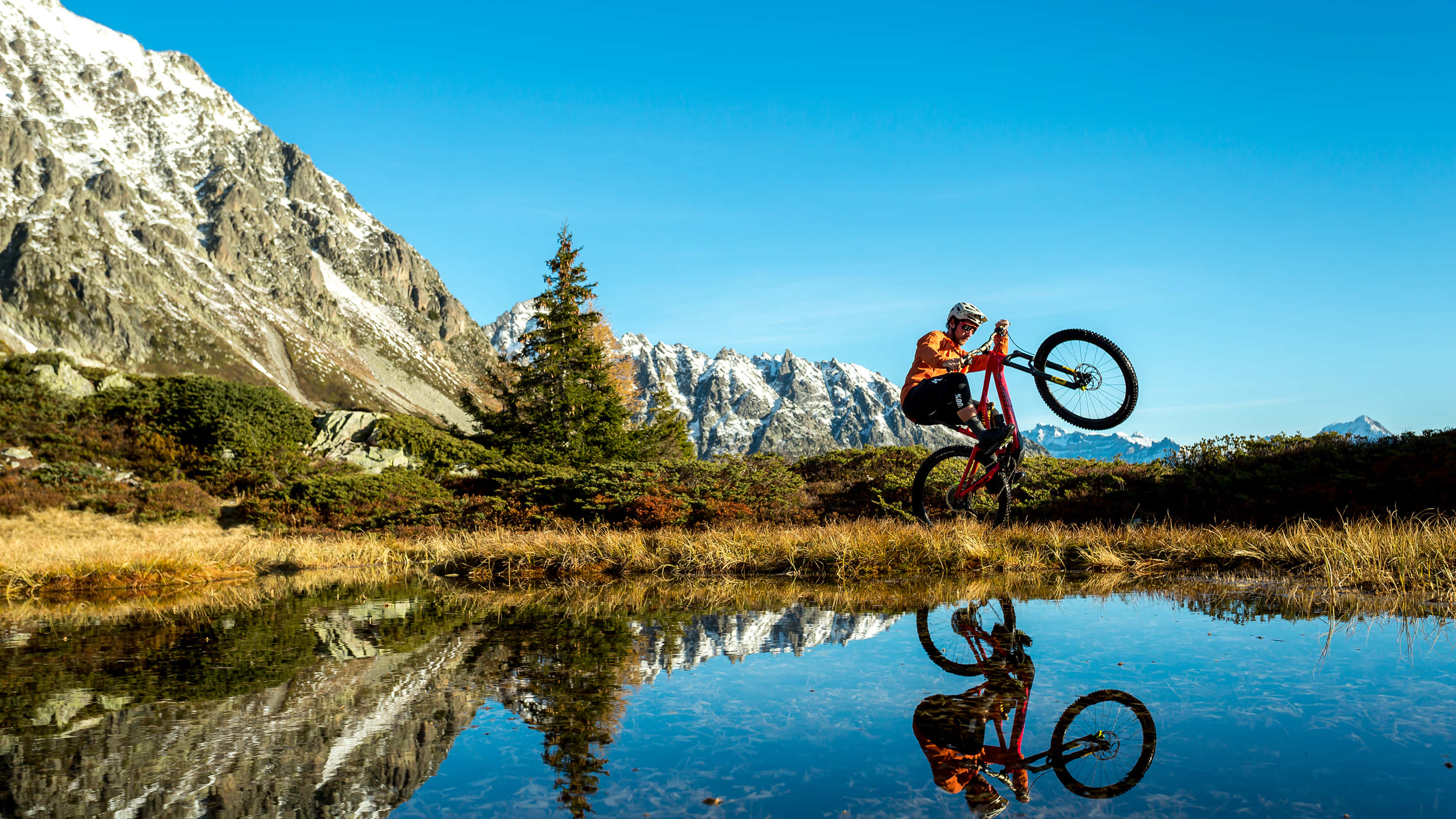 Specialized Mountain Bike Parkour, snow-capped peaks, calm pond, 2K Desktop Wallpaper
