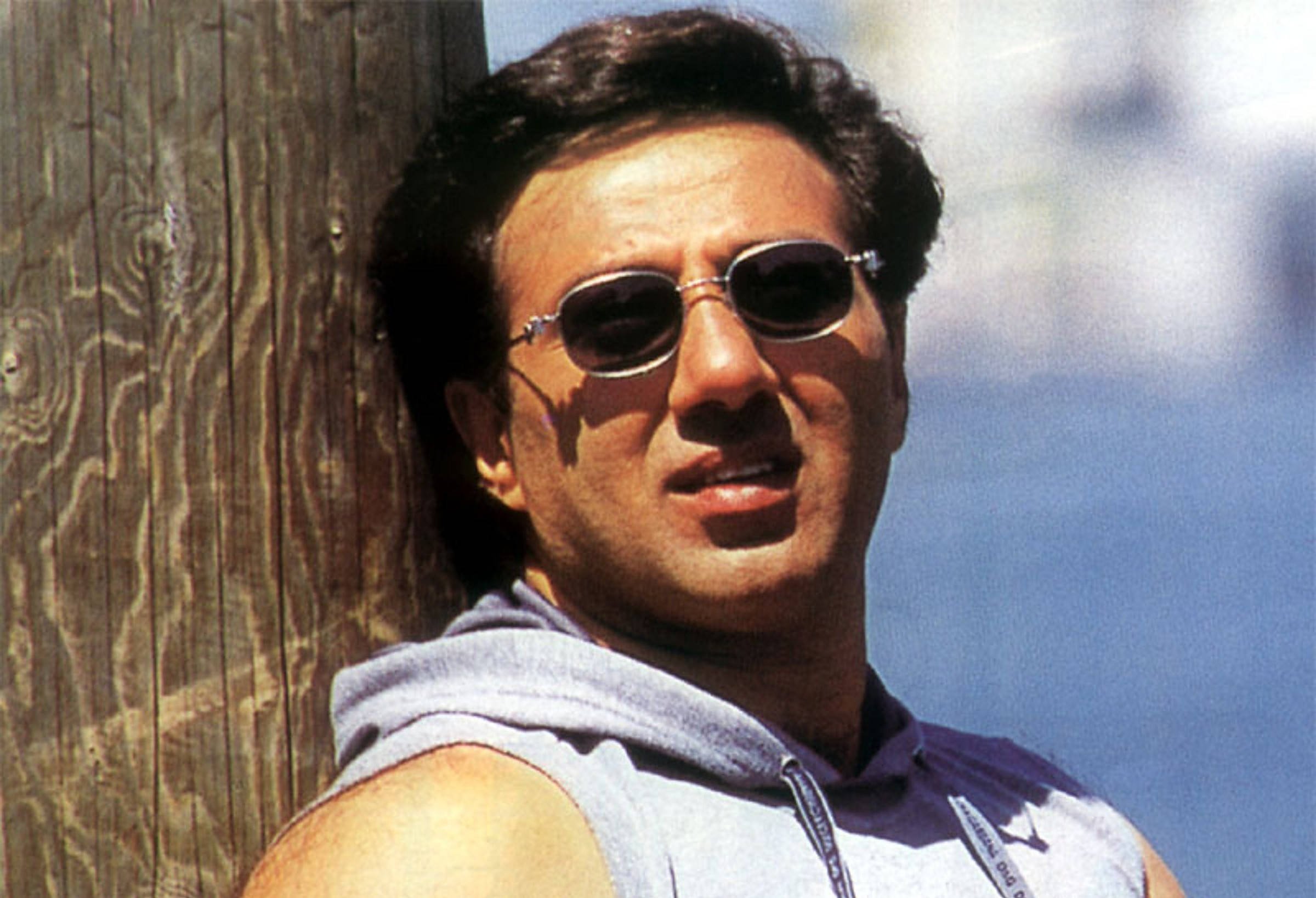 Sunny Deol, sunglasses, weathered wooden post, Full HD Desktop Wallpaper