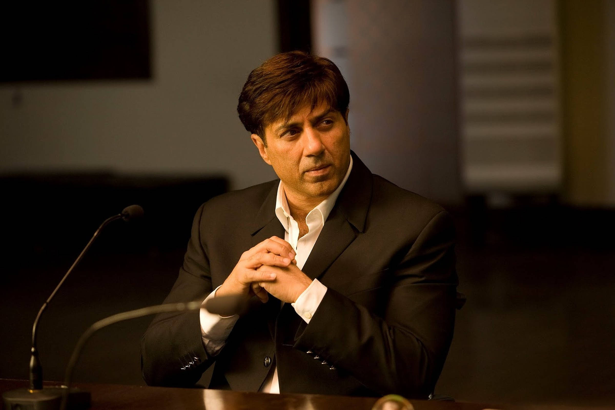 Sunny Deol, black suit, wooden table, Full HD Desktop Wallpaper