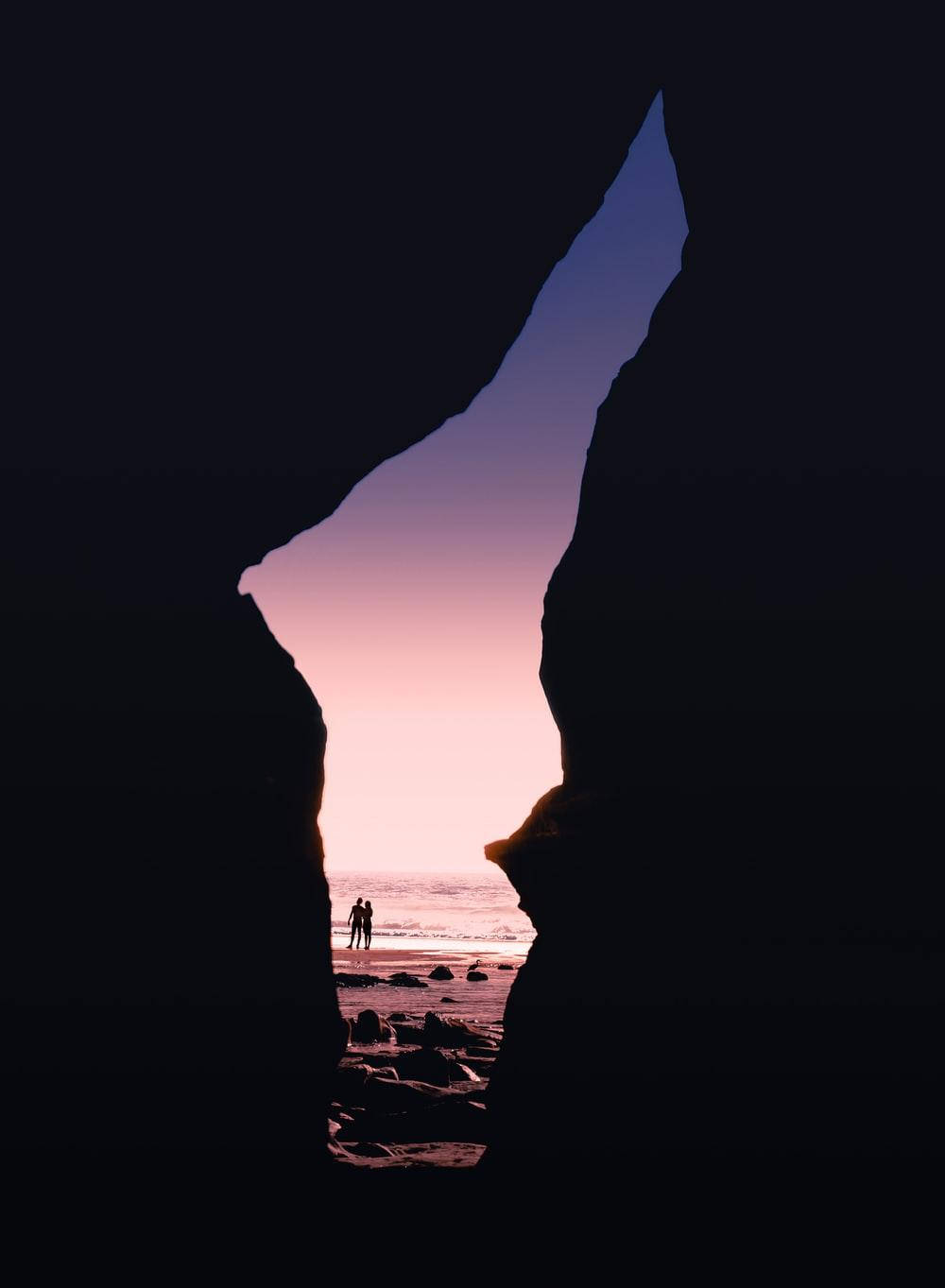Cave Sunset Aesthetic, silhouetted couple, rocky beach, HD Phone Wallpaper