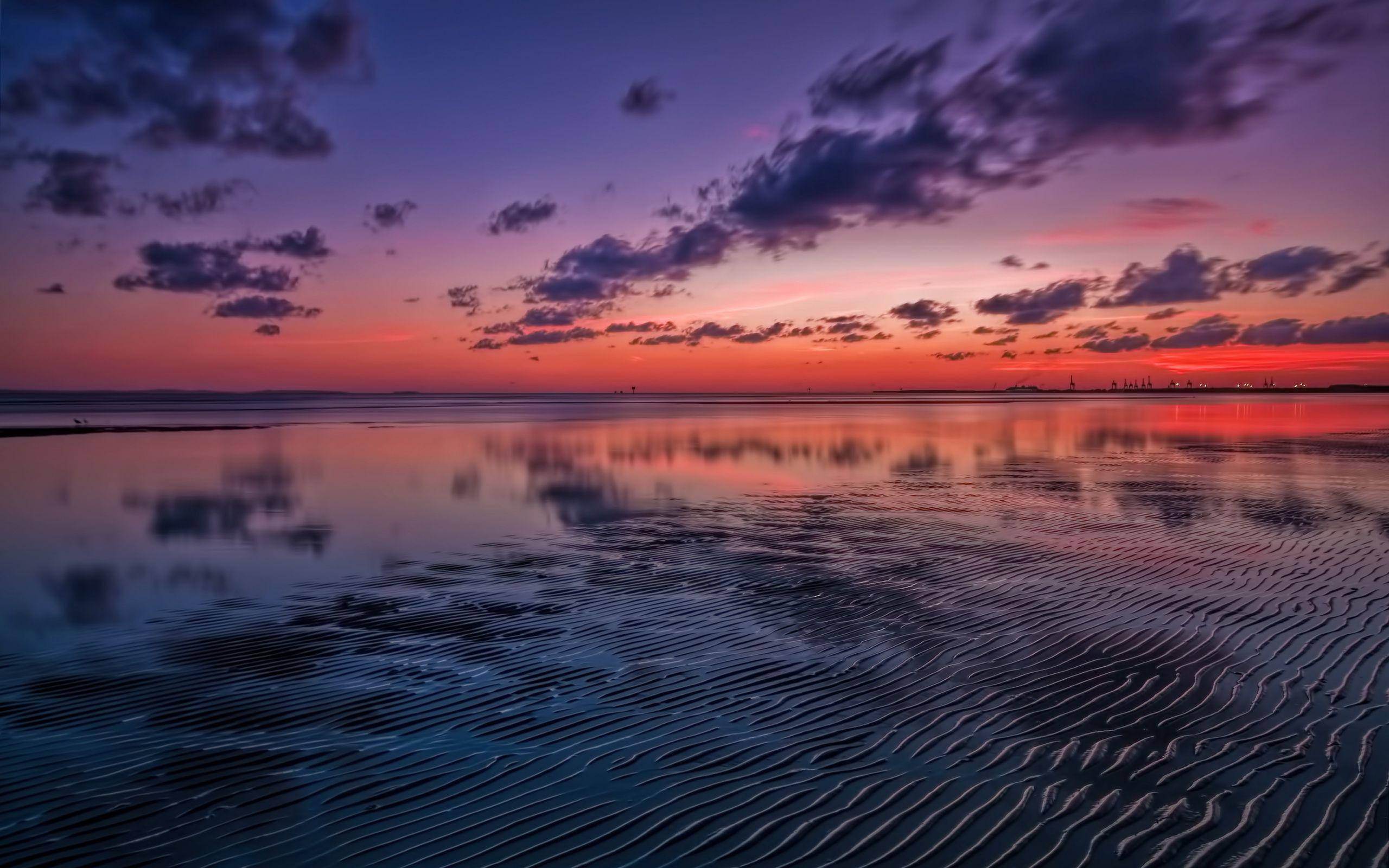 sunset, calm water surface, rippled sand patterns, 2K Desktop Wallpaper