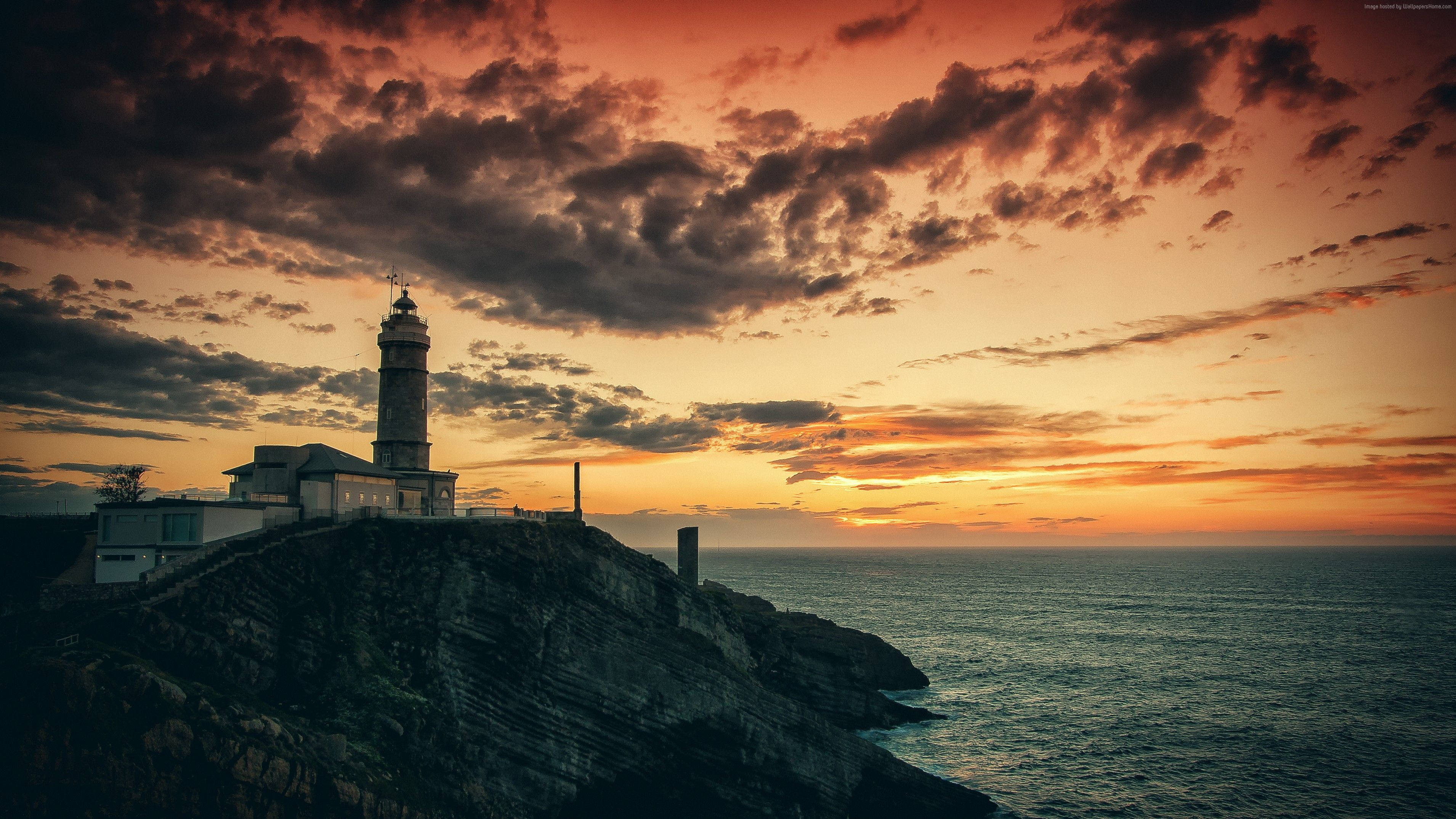 orange sunset lighthouse, rugged cliff, sunset, 2K Desktop Wallpaper