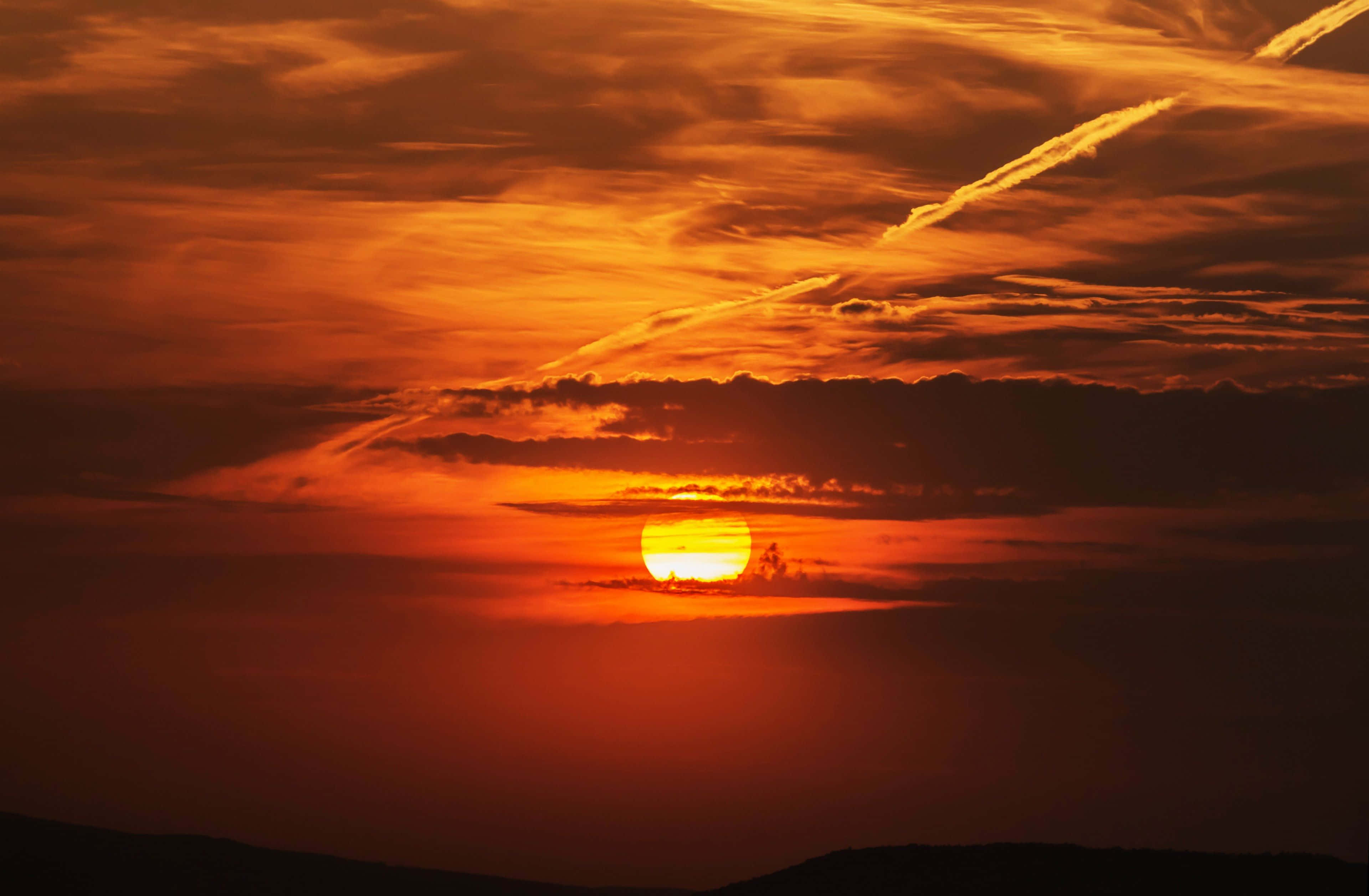 Sunset Hues, fiery orange sun, dark clouds, 4K Desktop Wallpaper