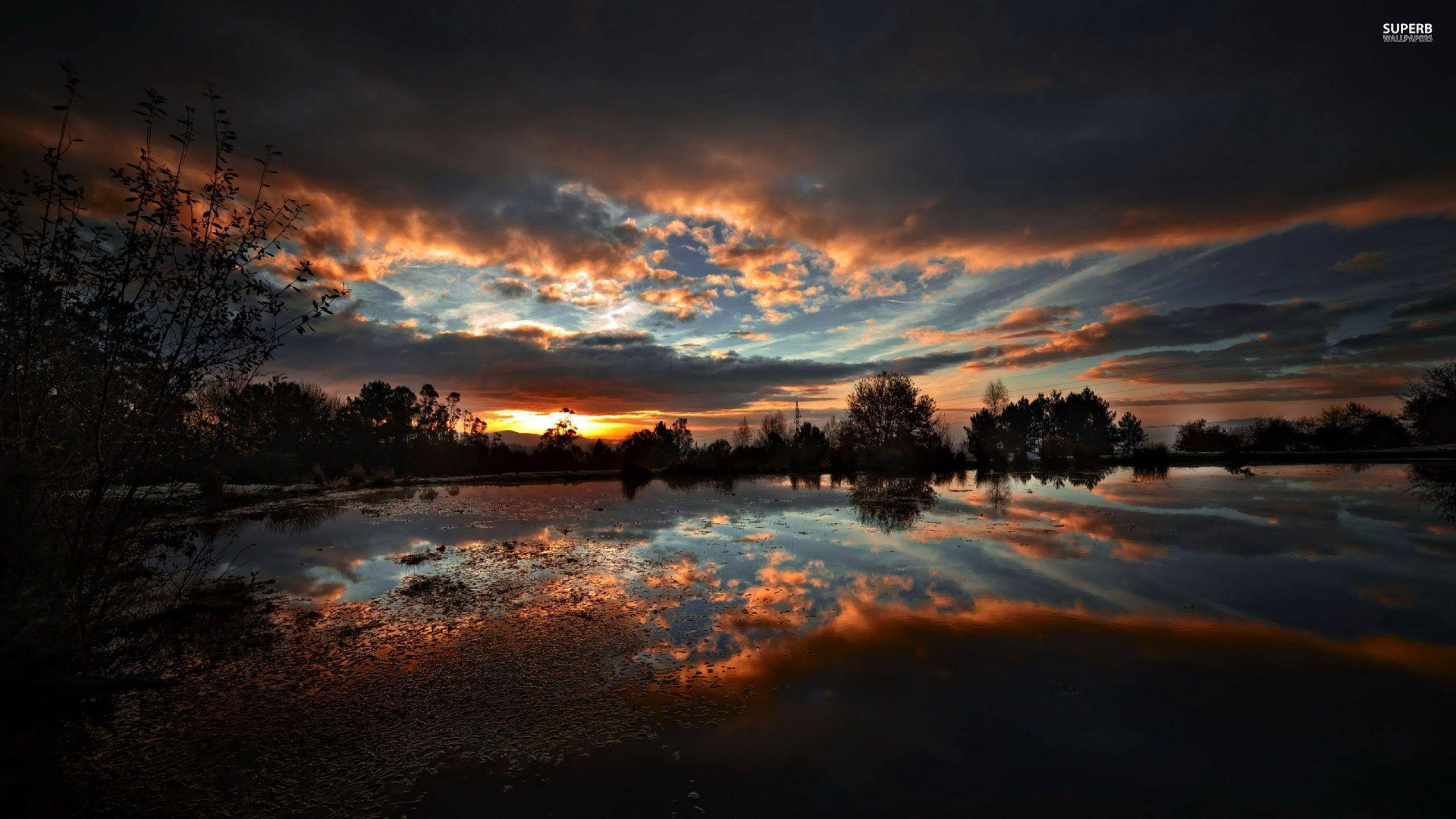 dark sunset, fiery orange clouds, calm pond, 2K Desktop Wallpaper