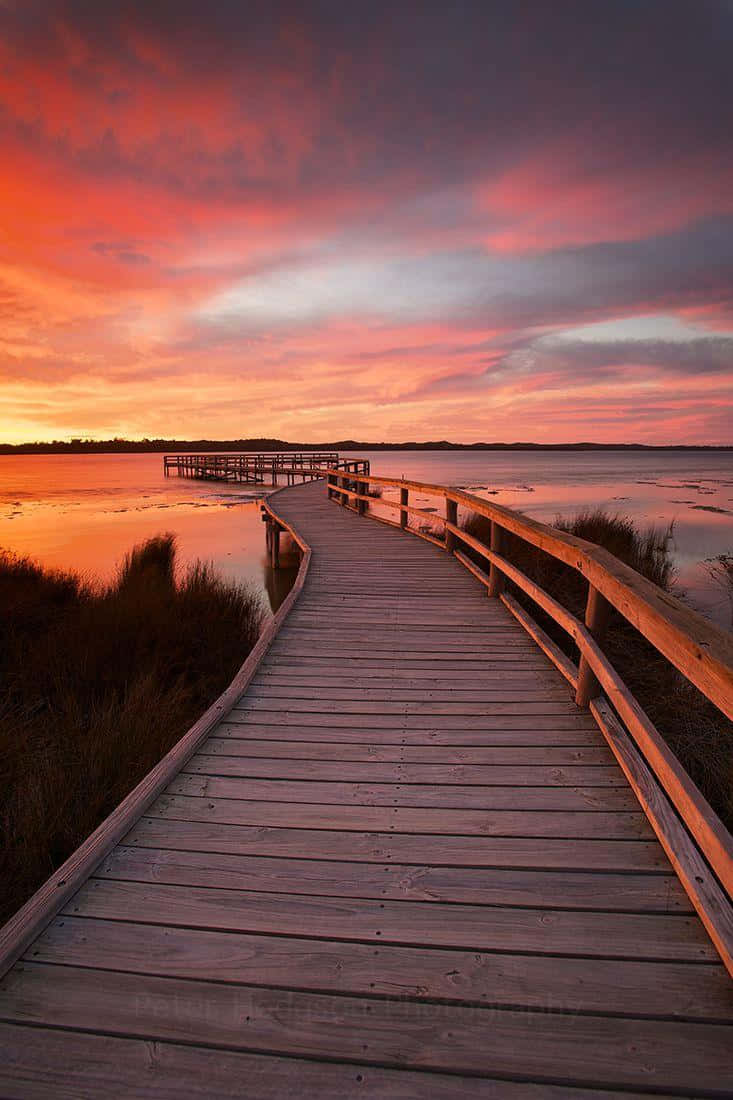 wooden boardwalk, distant pier, fiery sunset sky, SD Phone Wallpaper