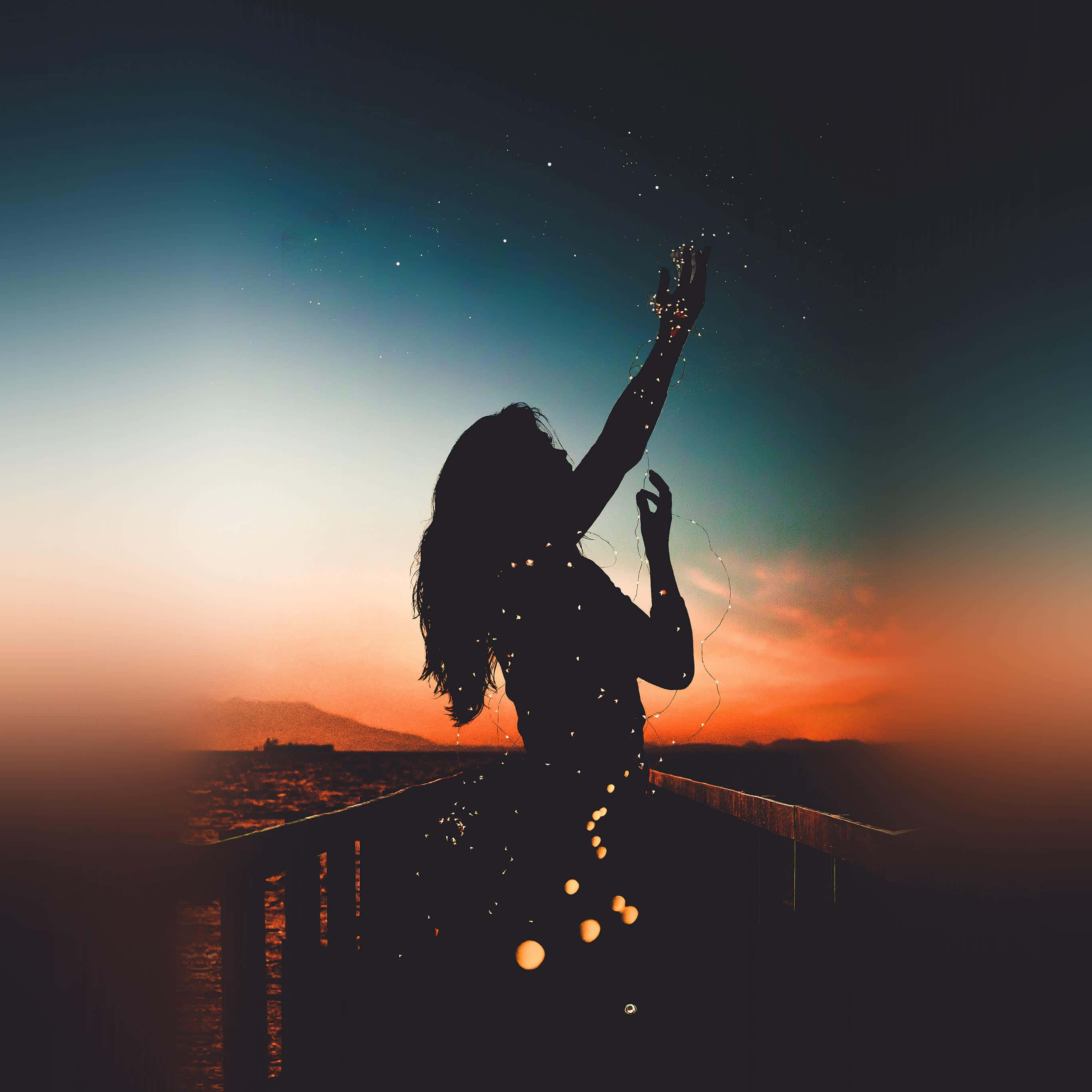 sunset silhouette, person reaching toward stars, pier, 2K Desktop Wallpaper