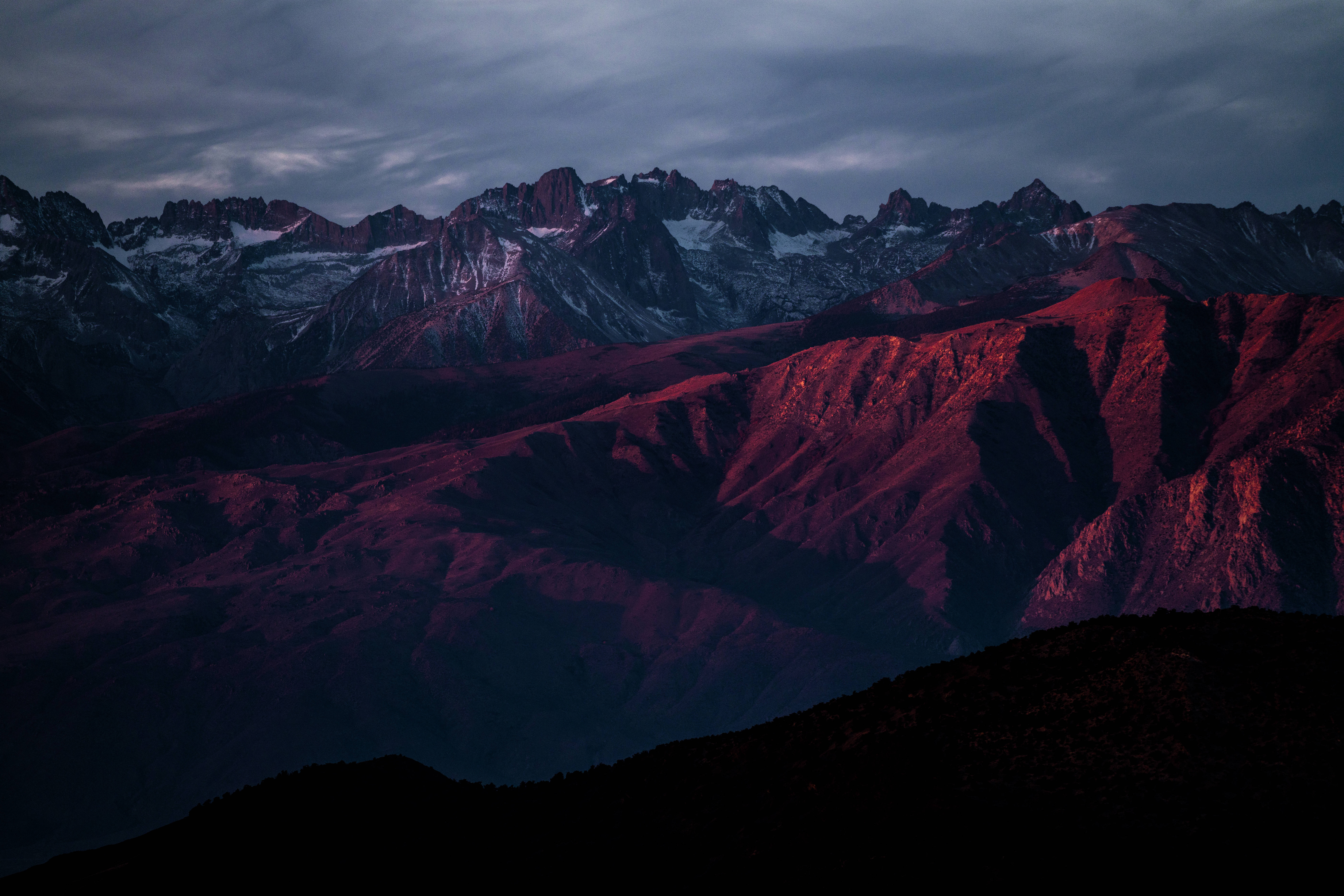 mountain range, deep red twilight light, snow-capped peaks, 8K Desktop Wallpaper
