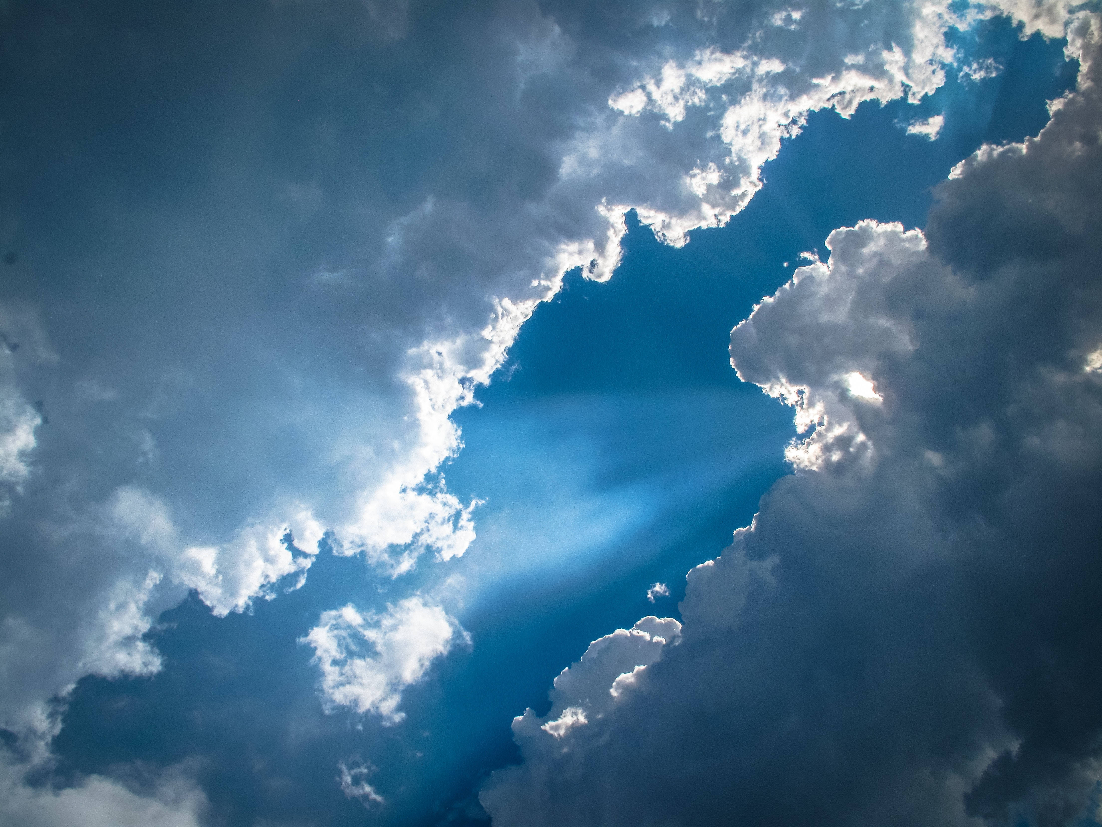 blue sky, dramatic dark clouds, sunlight beams, 4K Desktop Wallpaper