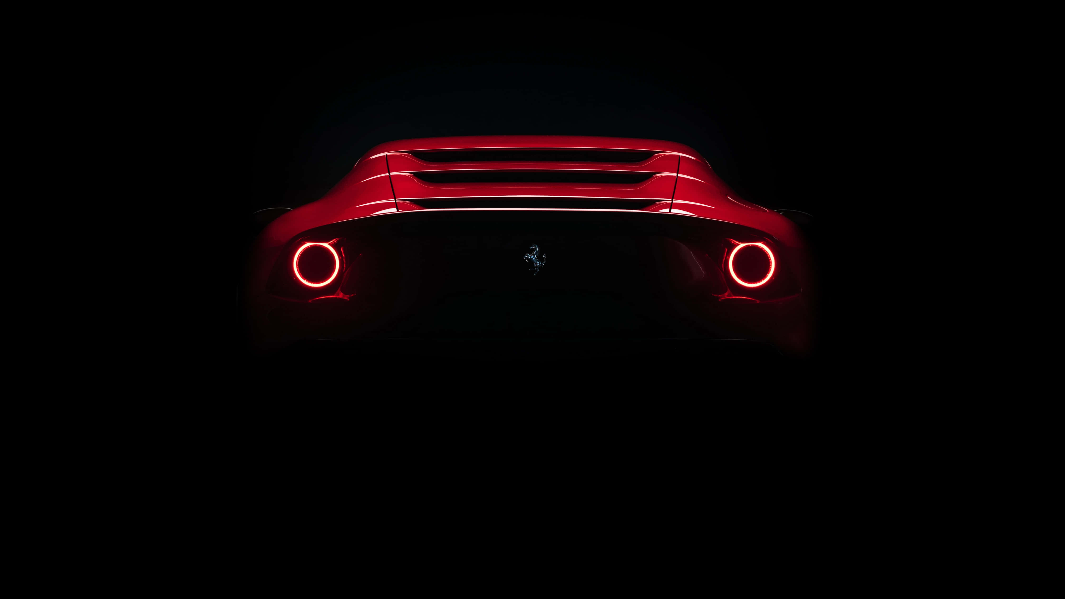 red Ferrari, circular taillights, pitch-black background, 4K Desktop Wallpaper