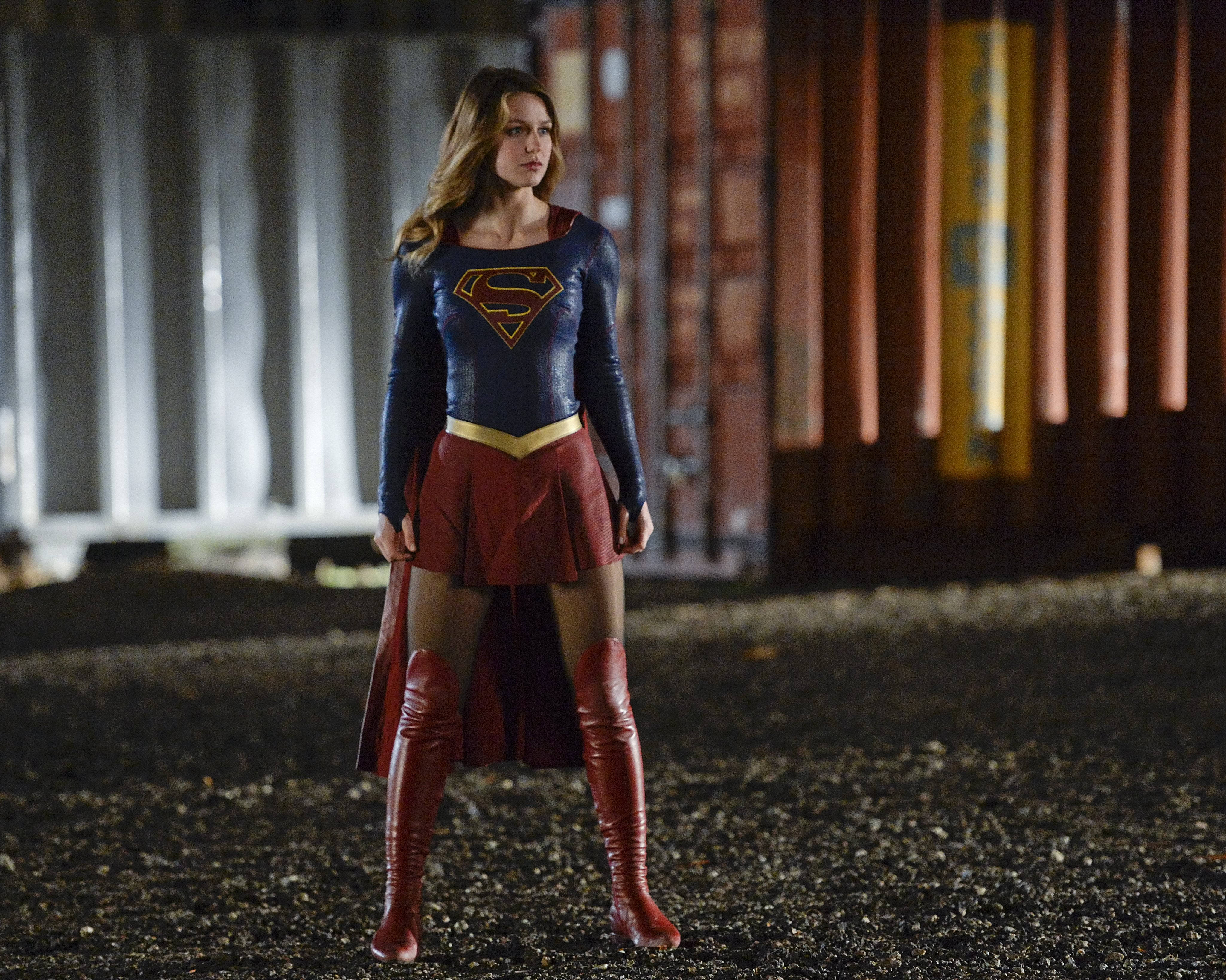 Supergirl, blue and red costume, gritty industrial yard, 4K Desktop Wallpaper