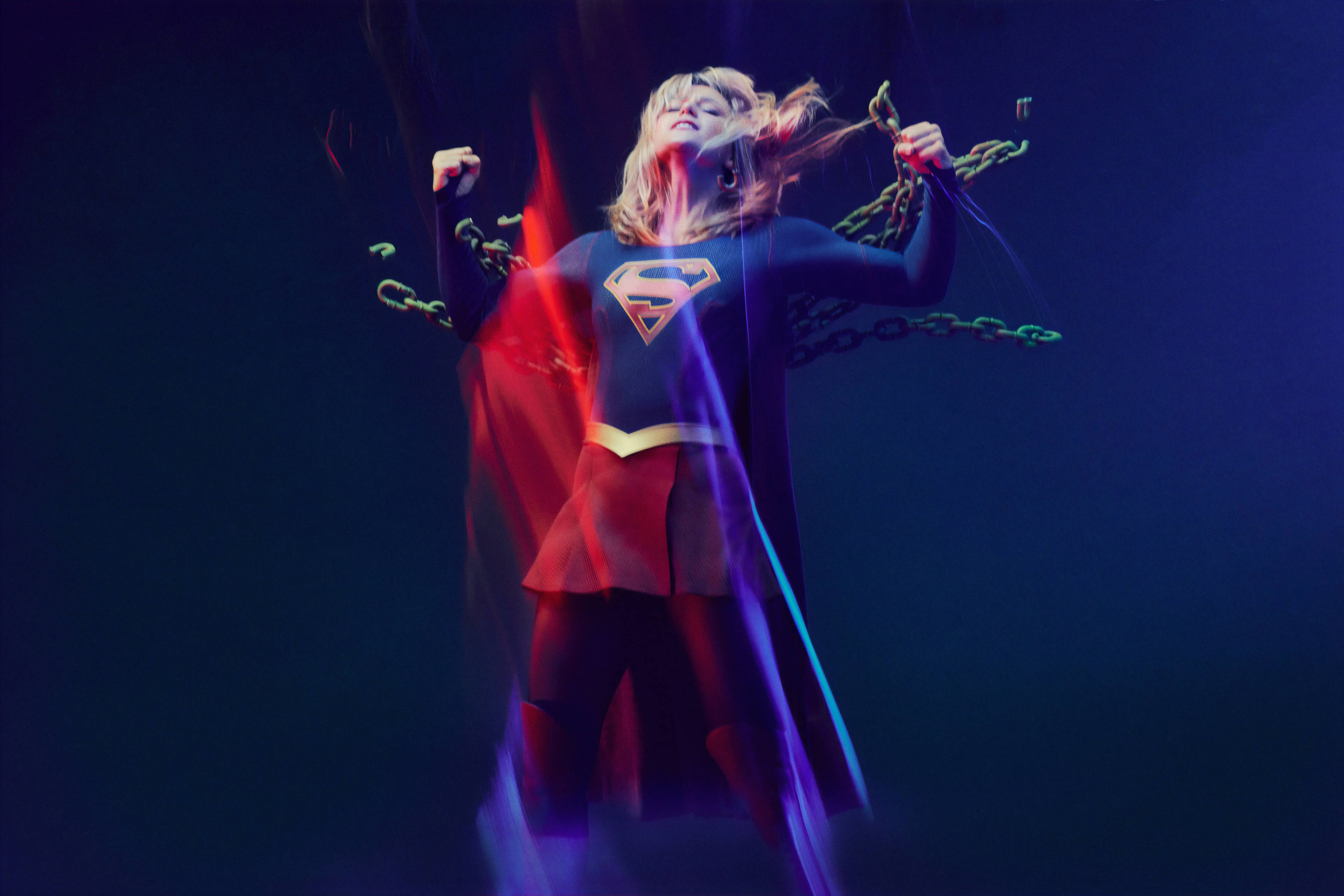 Supergirl, blue and red costume, glowing energy, 4K Desktop Wallpaper
